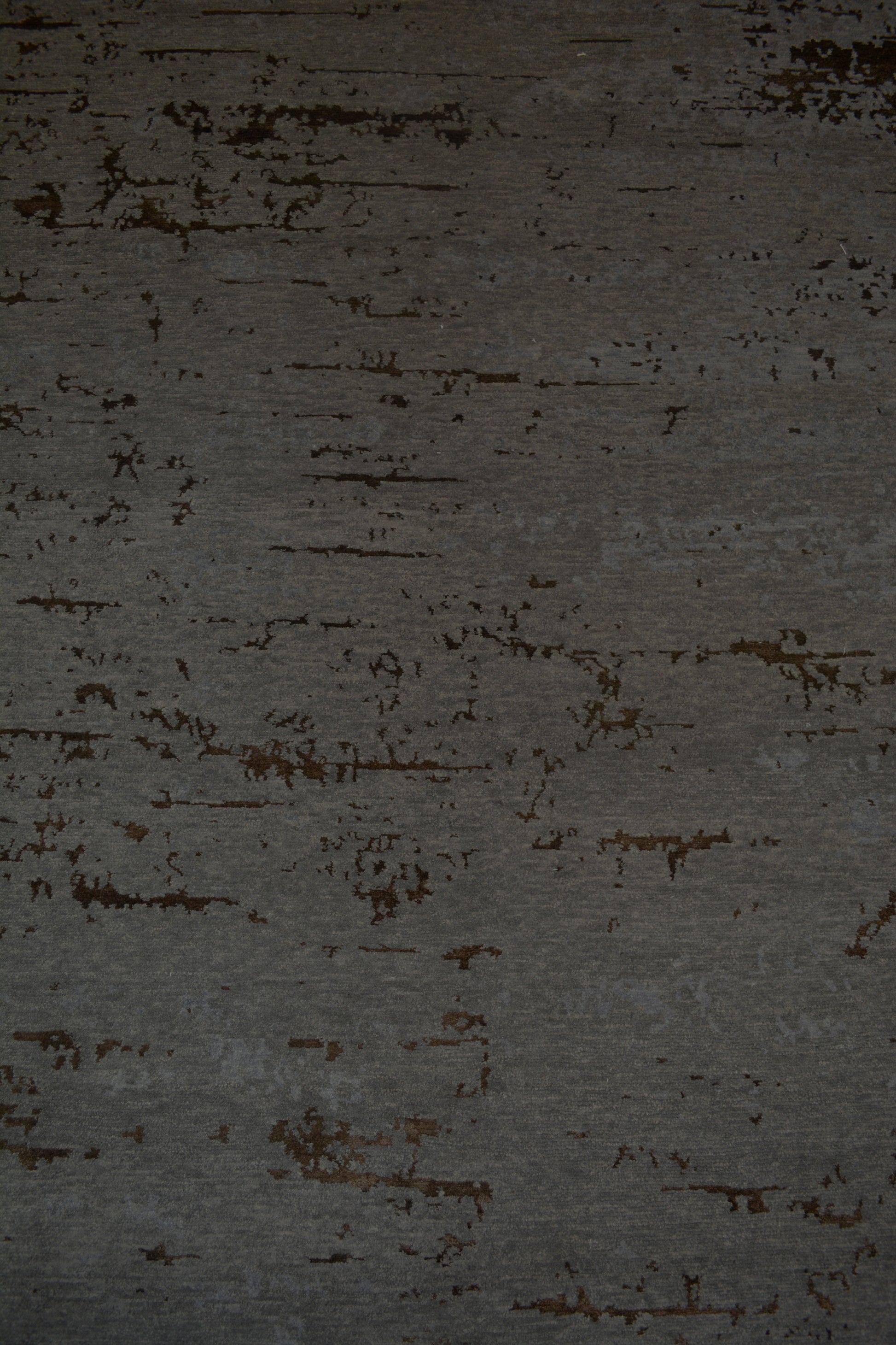 The center's close-up renders the texturized dark gray background with a few brown accents.