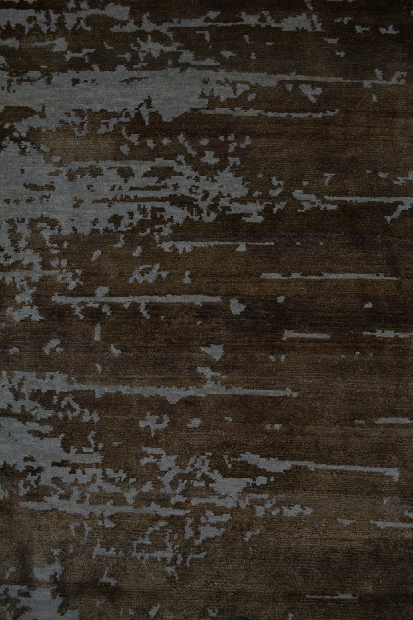 On the top right corner, the distressed horizontal brown lines show over the rug.