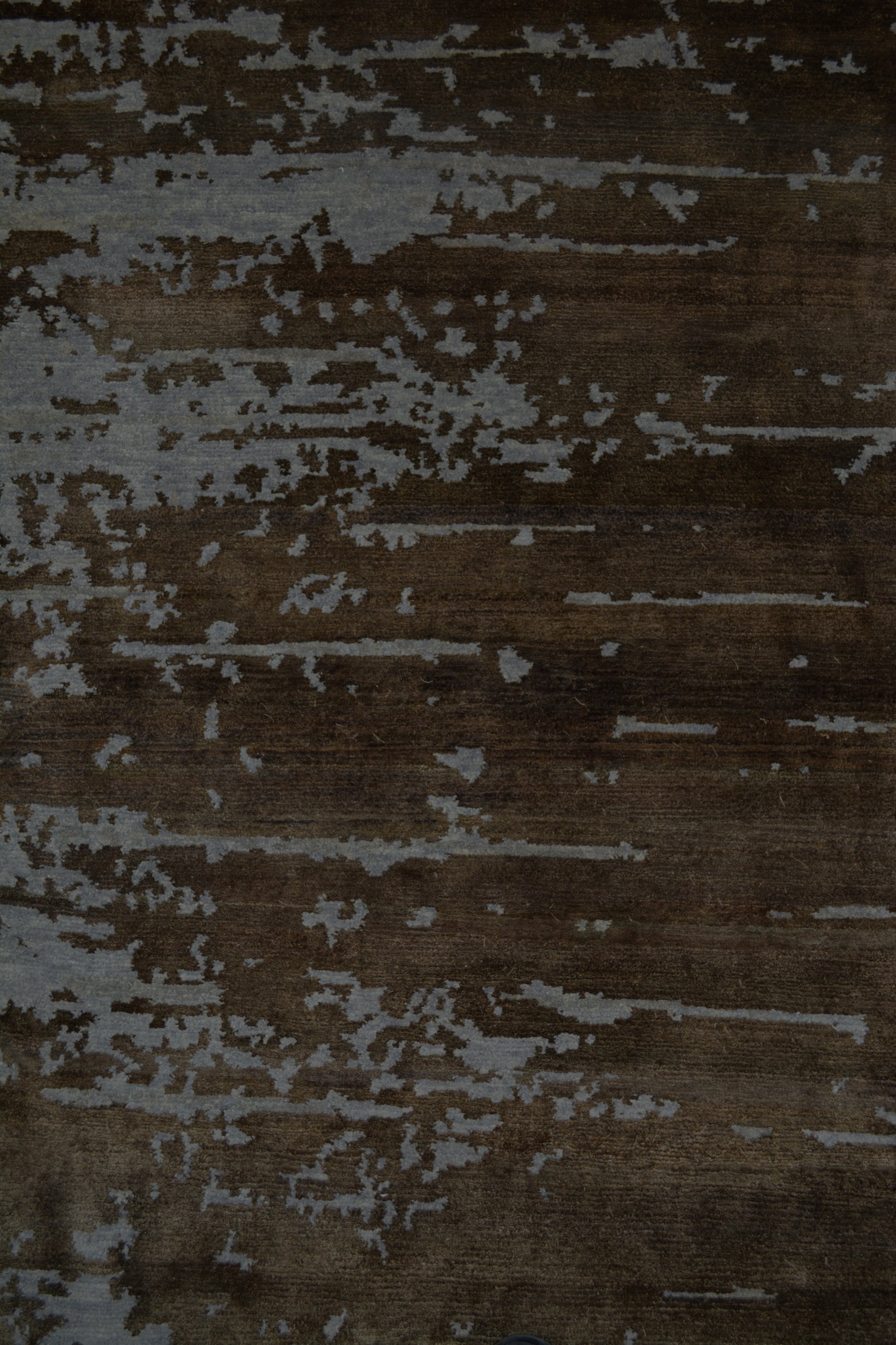 On the top right corner, the distressed horizontal brown lines show over the rug.