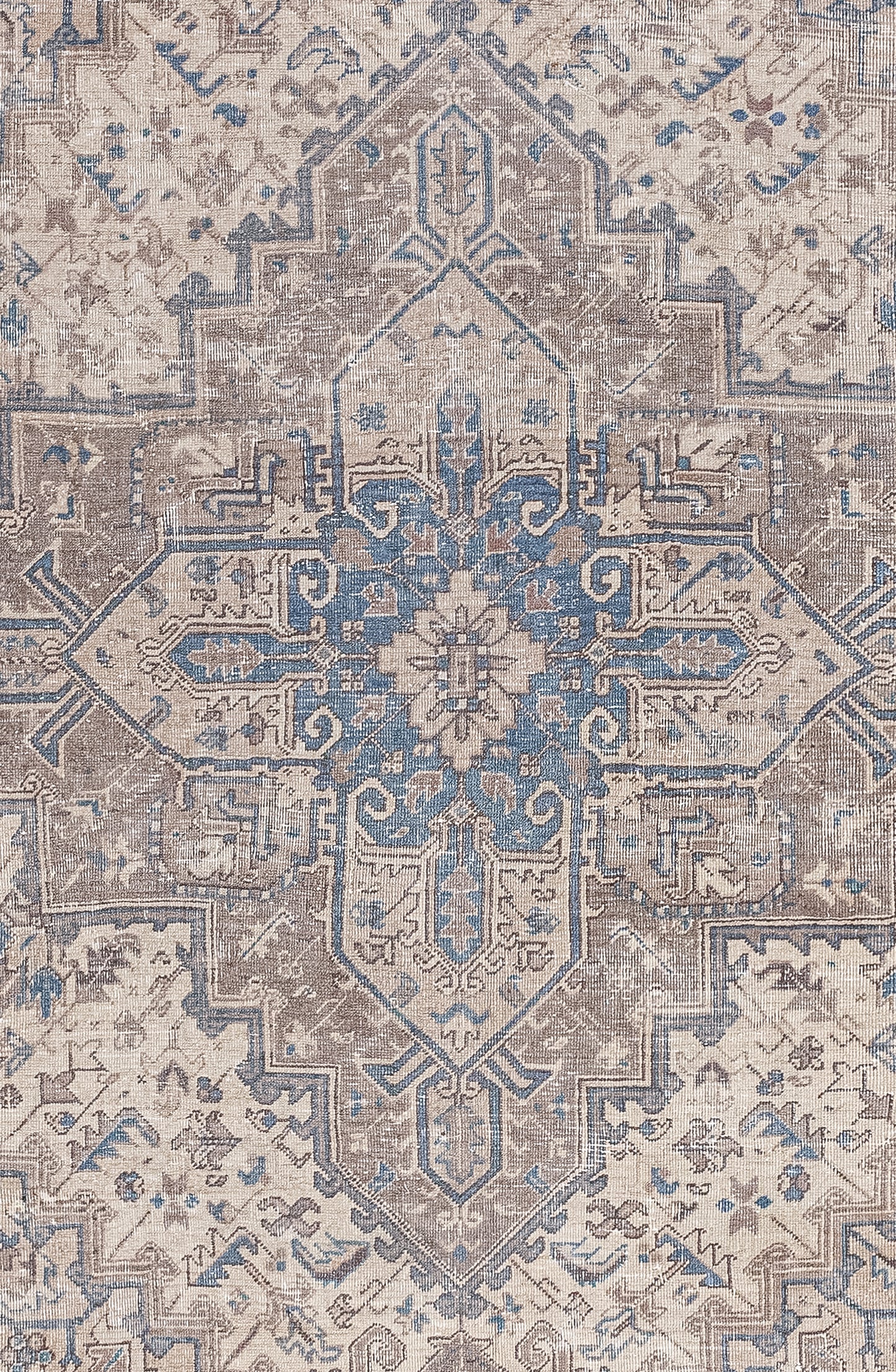 The center of the rug has a square cross that has nested others that have been filled with geometric shapes and symbols.