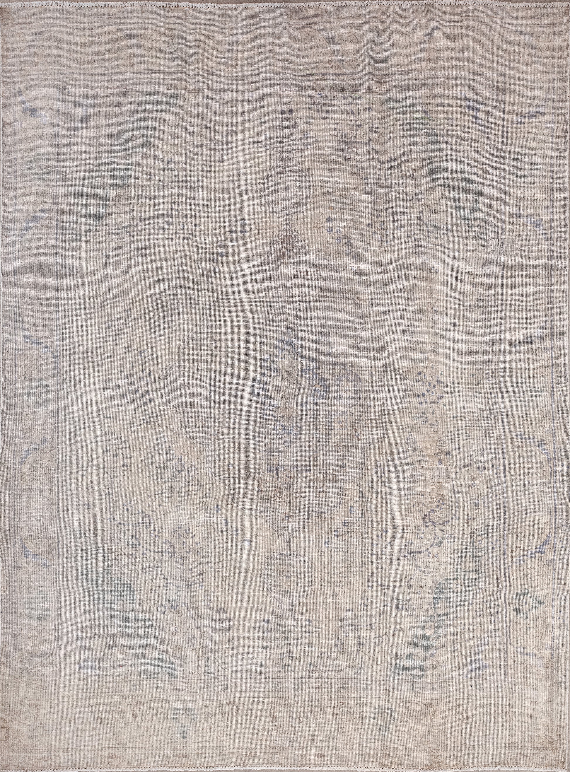 This traditional rug was woven in hues of royalty. The aged natural color scheme has beige for the background, gray for the pattern. The combination of both restrains the contrast.