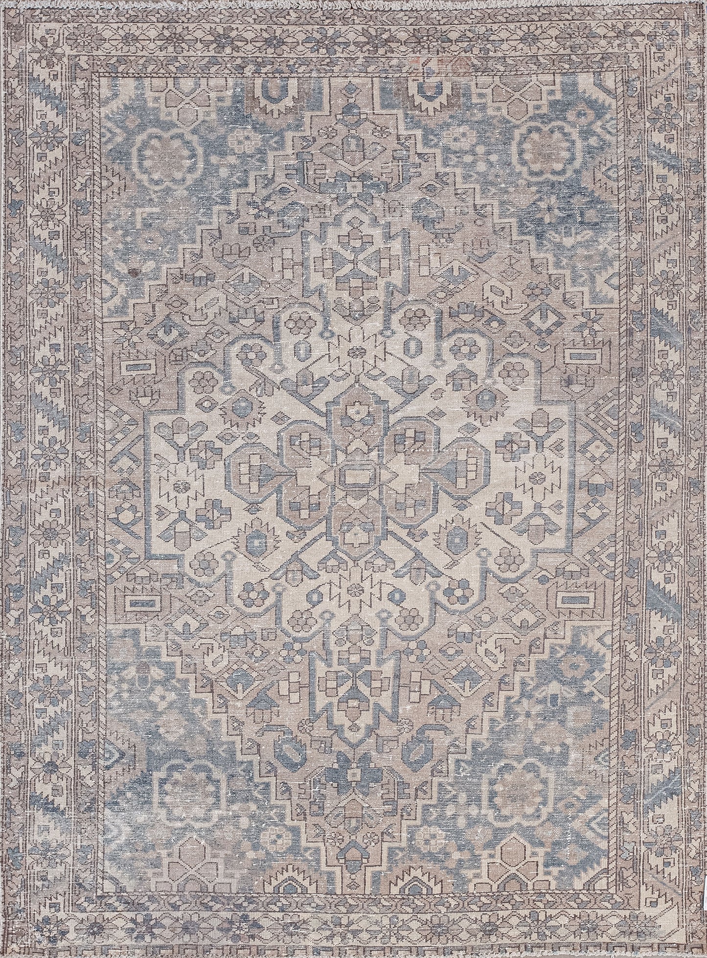 This pyramidal rug was woven with ancient symbols and tribal energy. The old-fashioned color scheme has beige, brown, and blue-gray.