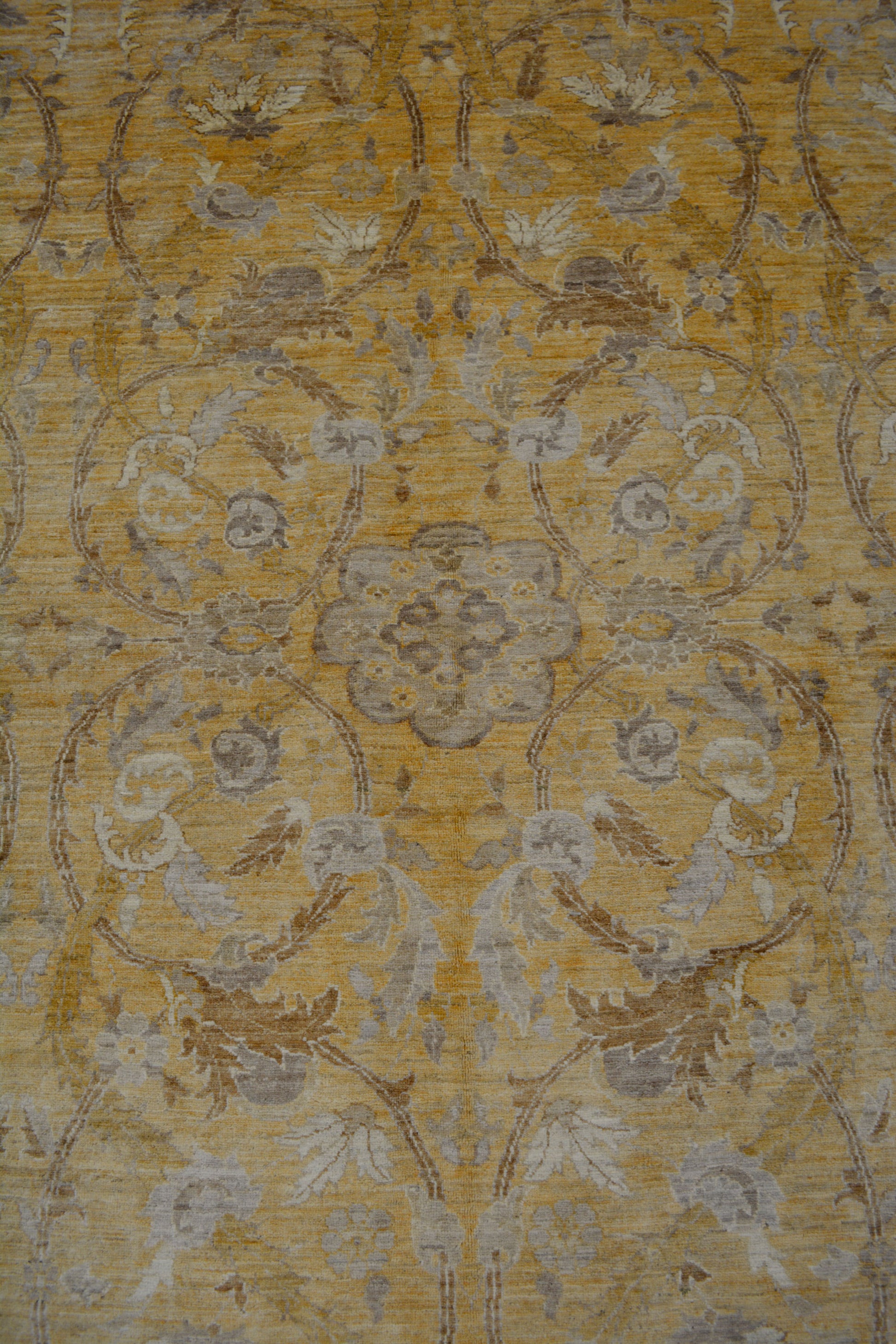 The center of the rug features a gray mandala with circular branches enclosing leaves and flowers around the central mandala.