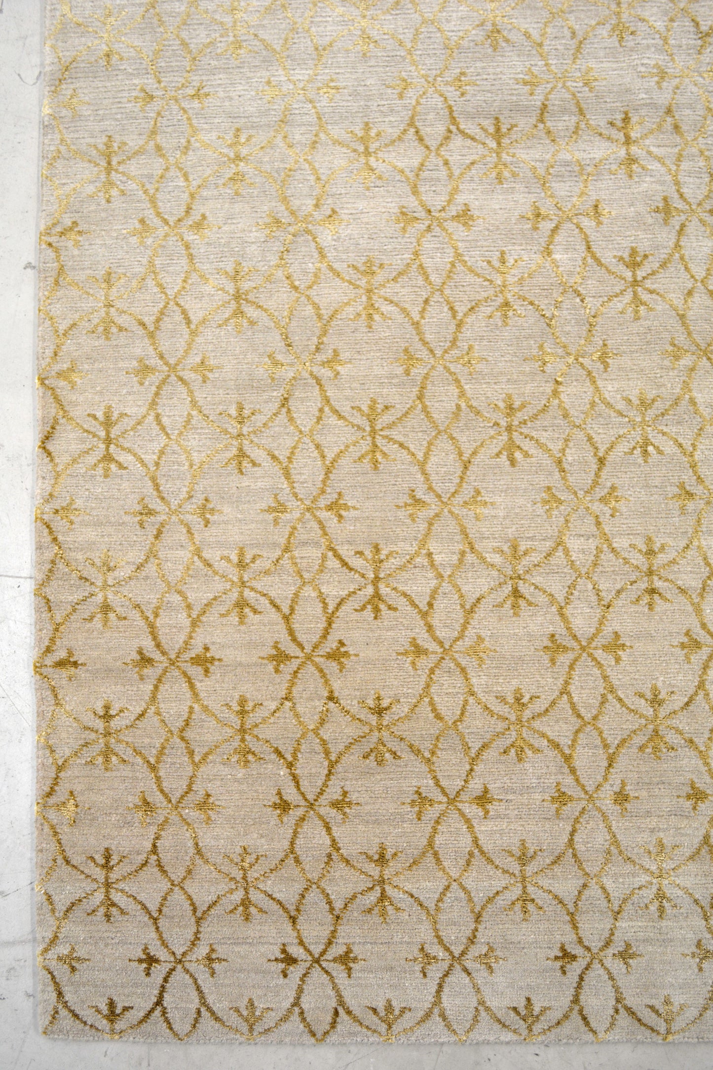 On the bottom left corner, the pattern starts and takes over the whole rug rendering symmetrically.