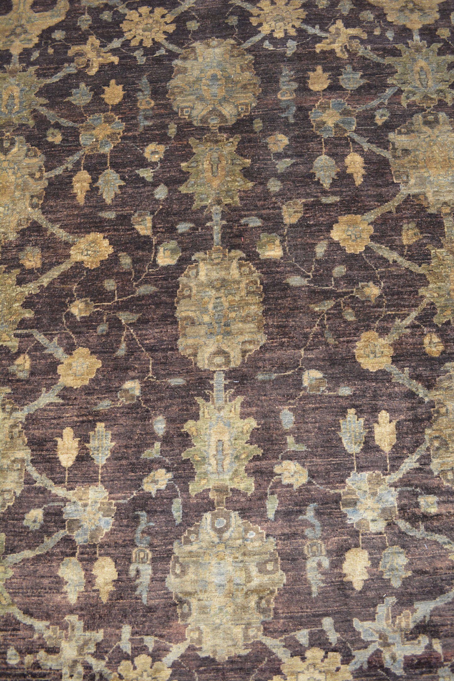 The symmetric pattern displays flowers, leaves, and ornaments arranged symmetrically.