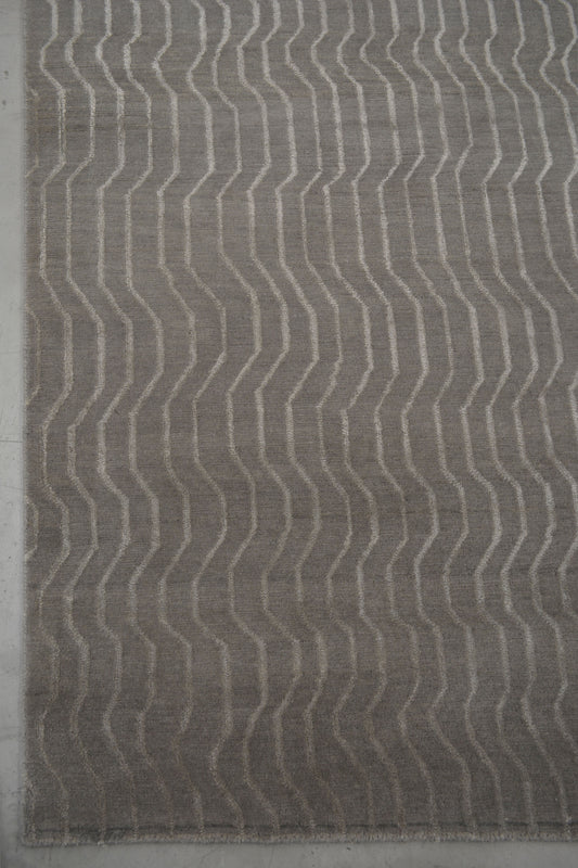 From the bottom left corner, the wave pattern takes over the whole rug symmetrically.