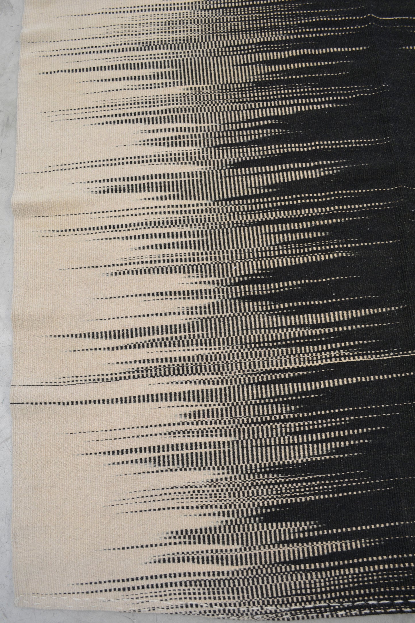 The bottom left corner shows the black and gray frequencies coming from the right to fade into the beige background.