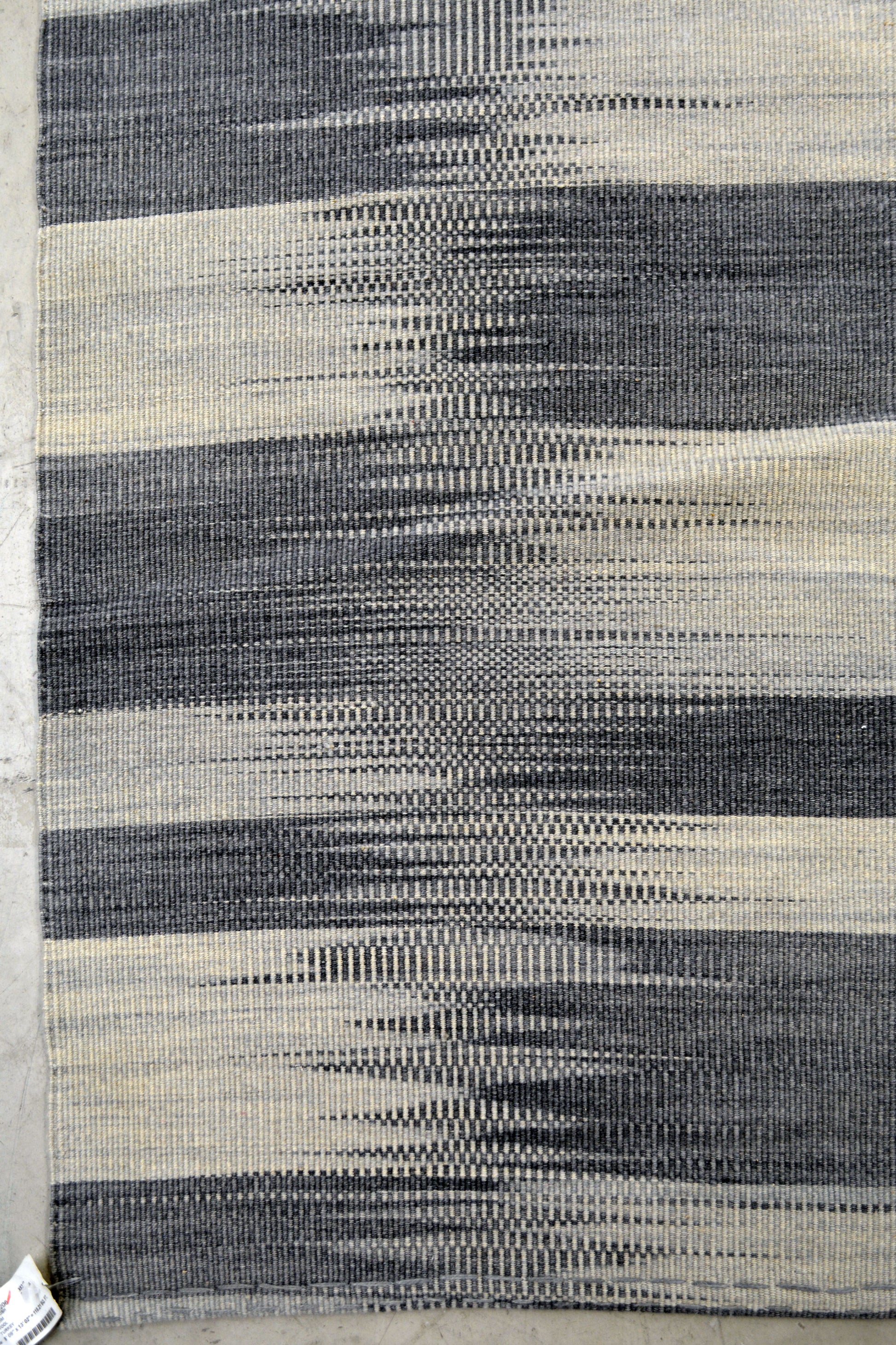 The classic rug's style renders an abstract checkers board representation.