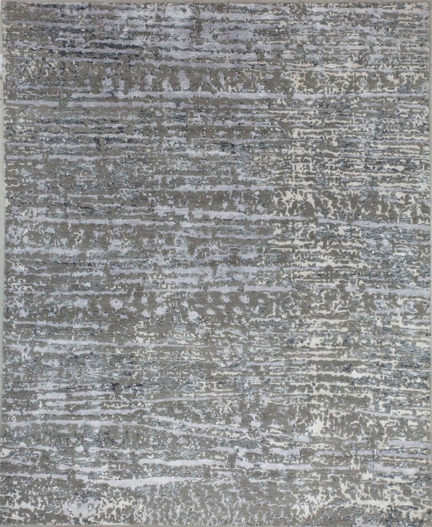 Modern carpet knitted with an animal print style. The color scheme is gray, beige, and black accents.