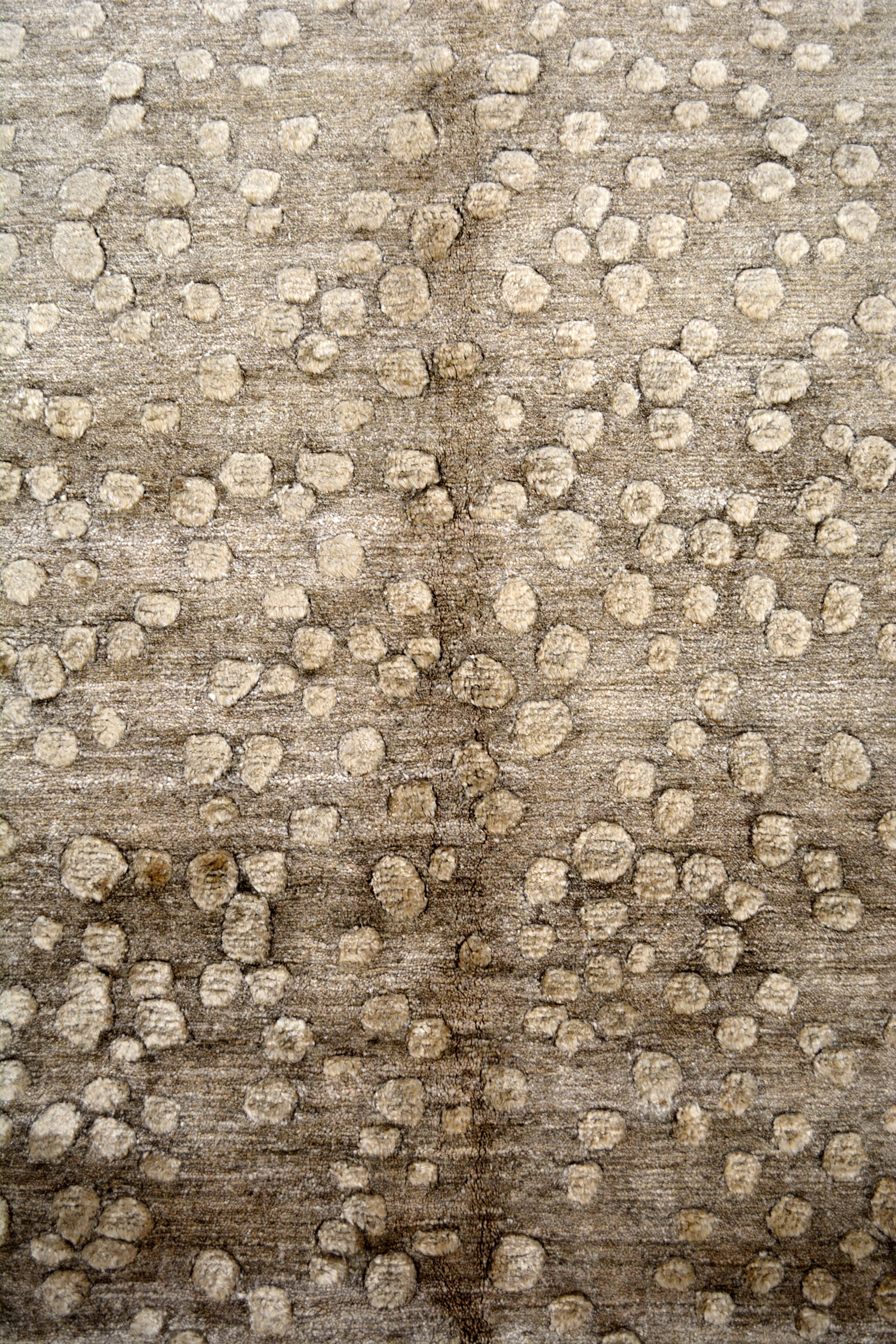 The pebbles are showing randomly over the whole rug. Also, there are no frames for this rug.
