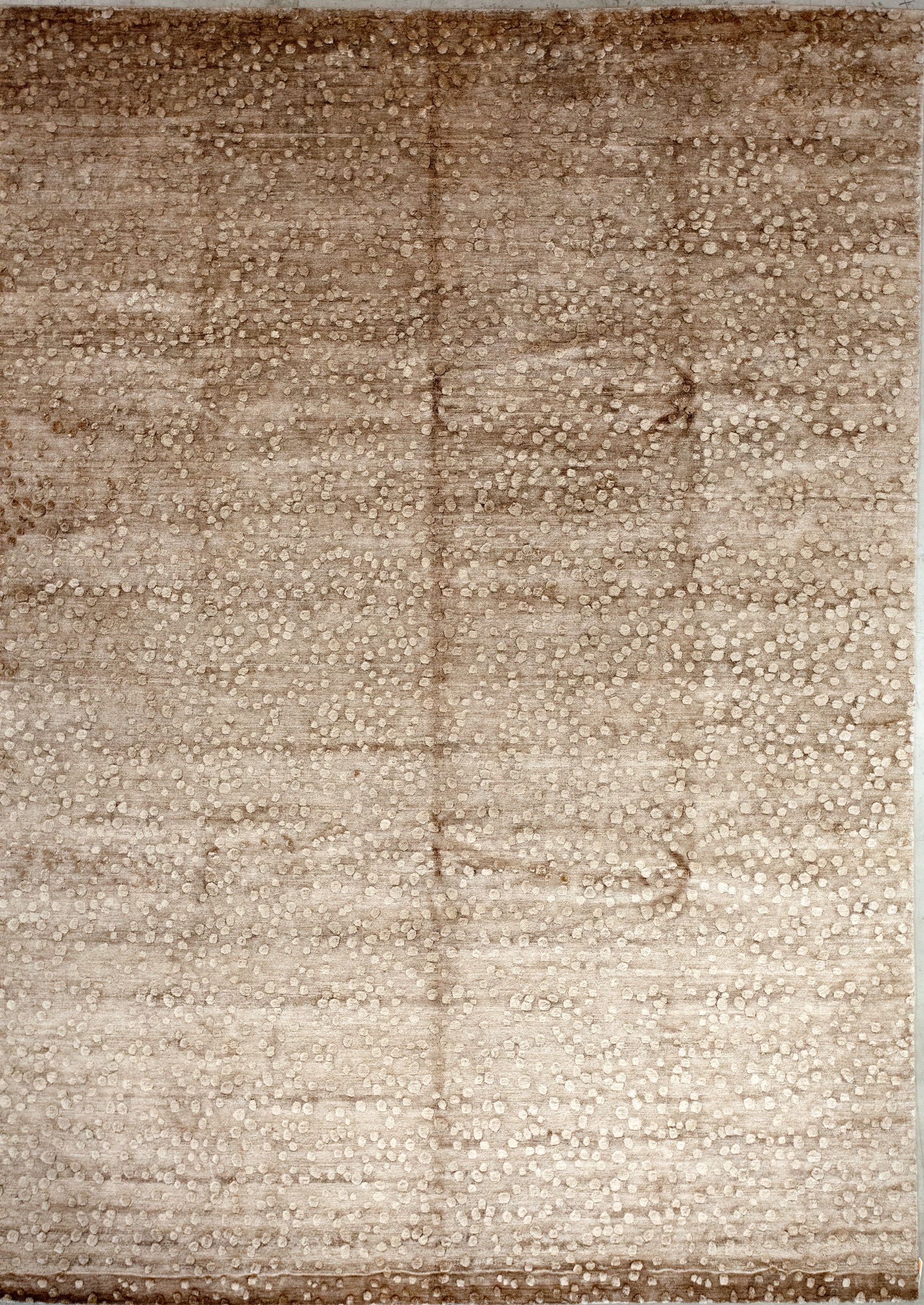 Fashionable rug has a brown background and pebbles texture.