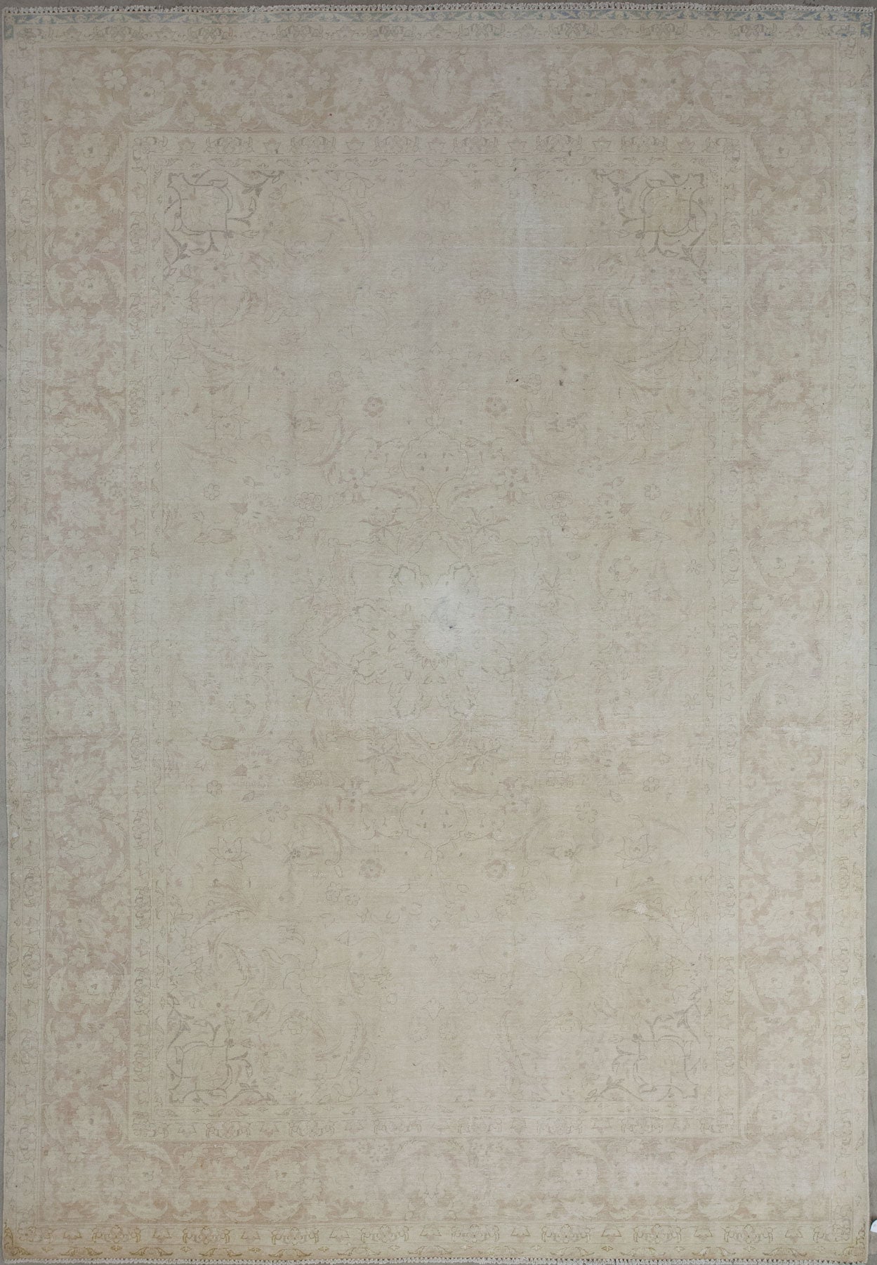 Conventional rug knitted with beige background and brown pattern.