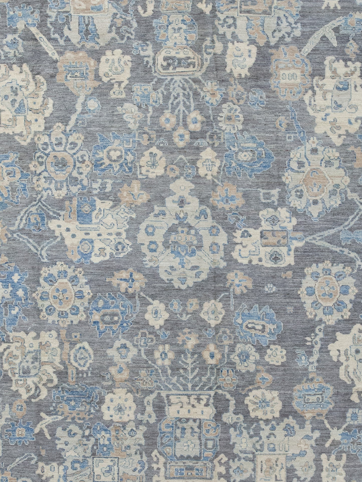 The center's close-up has a gray brownish background with beige corals and shield full of blue details.