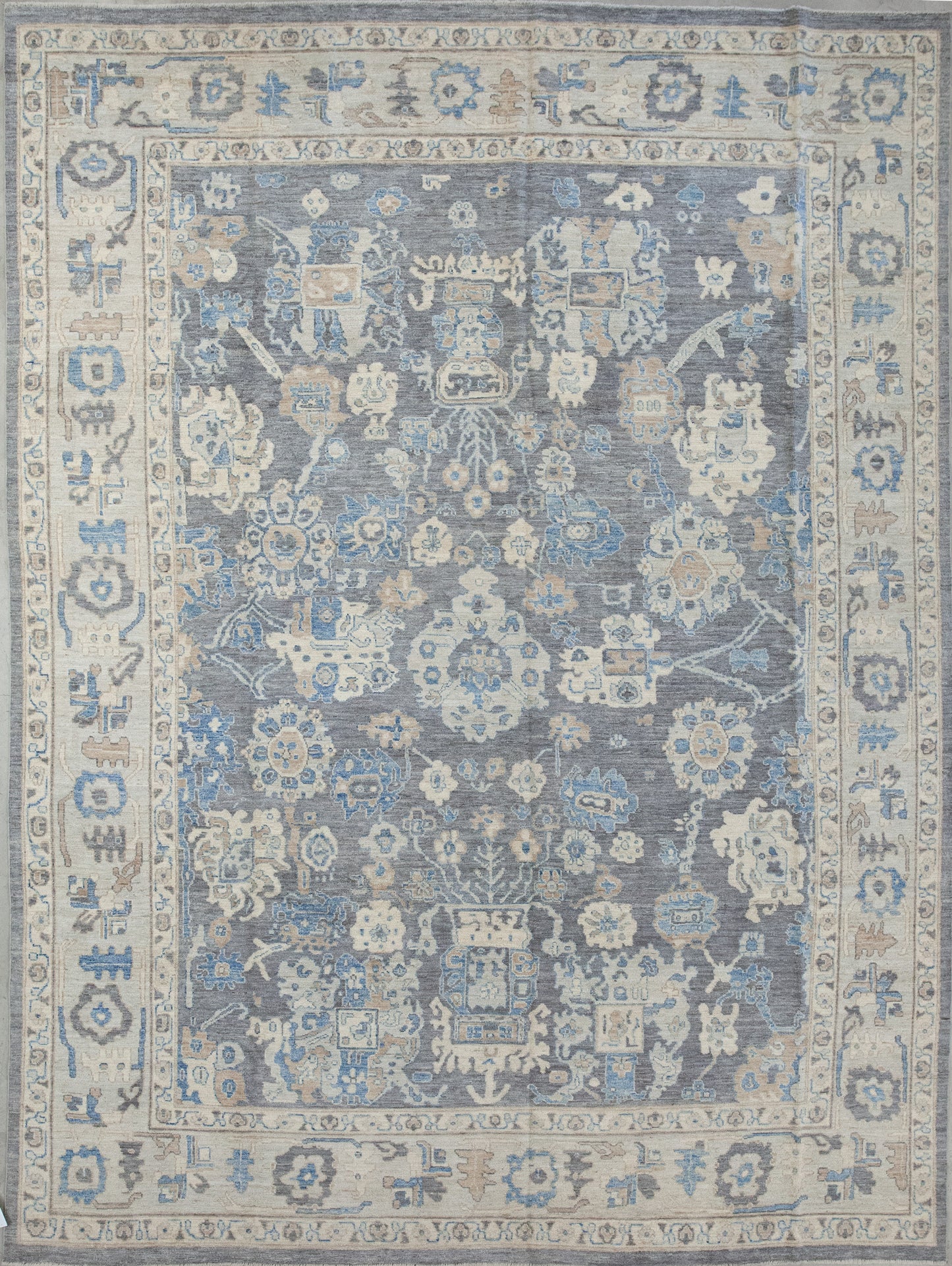 Classic rug comes with a sober color scheme which has gray, brownish, beige, and blue accents. The design renders abstract corals, flowers, and shields.