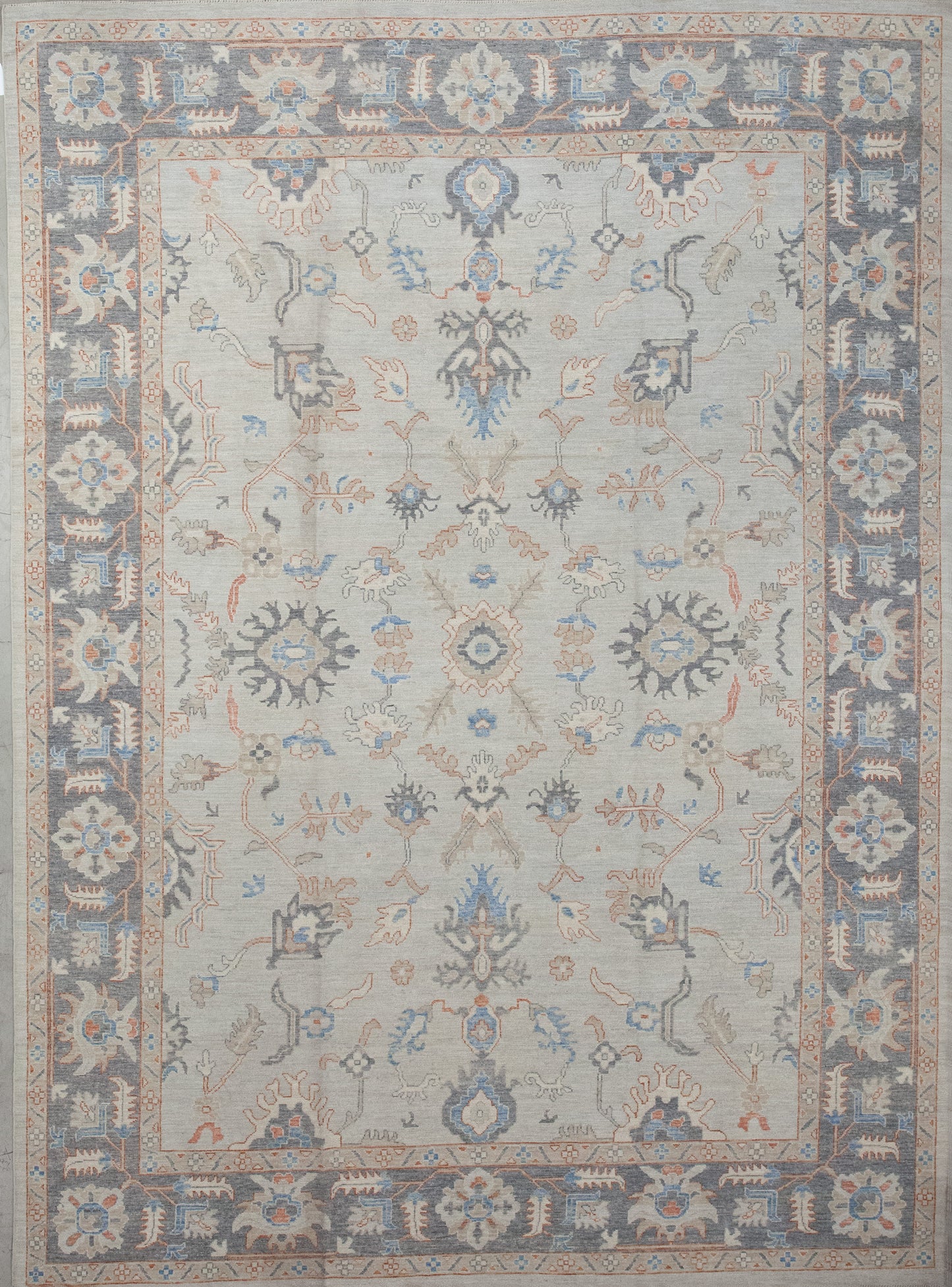 First-rate carpet comes with an elegant color scheme which has variations of gray, orange, and blue. The symmetrical design renders thin branches, autumn leaves, and snowflake shapes.