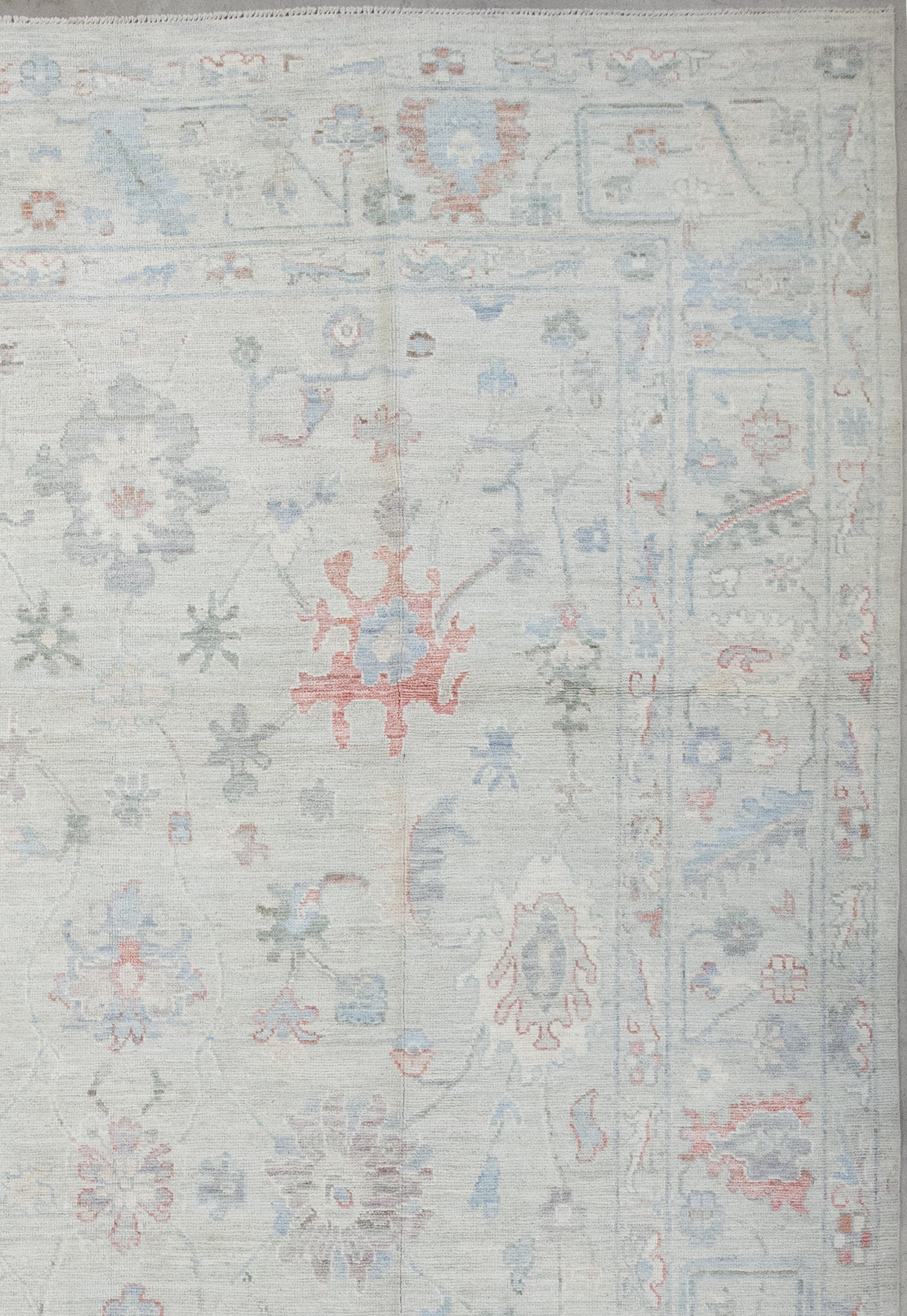 the borders barely display small flowers and leaves in red, white, and blue, while the frame contains a complex abstraction of nature.