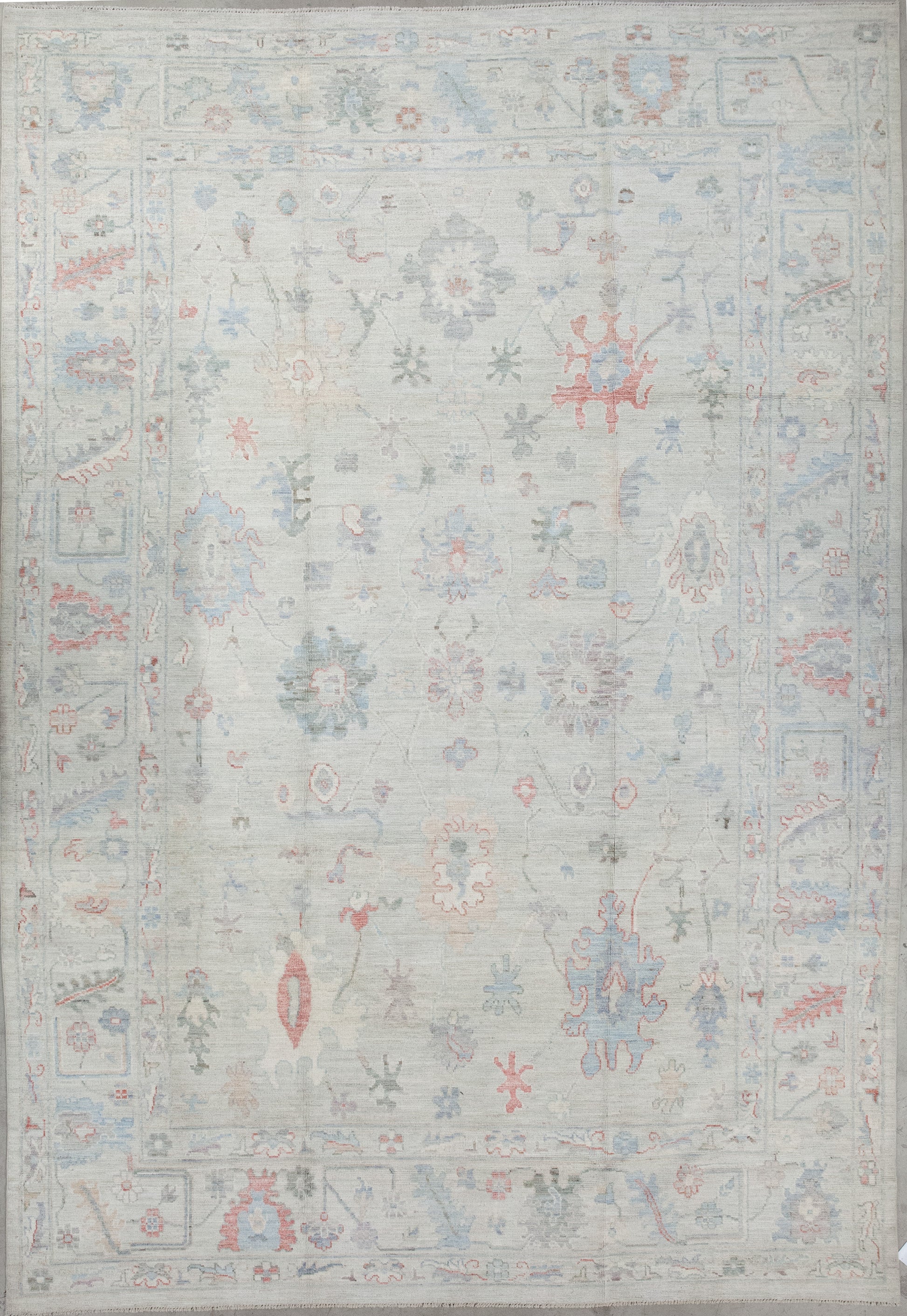The elegant rug was woven with gray as the dominant color. On top of the rug, there is a design which renders abstract sunflowers, thin branches, paint splatters, and long leaves.