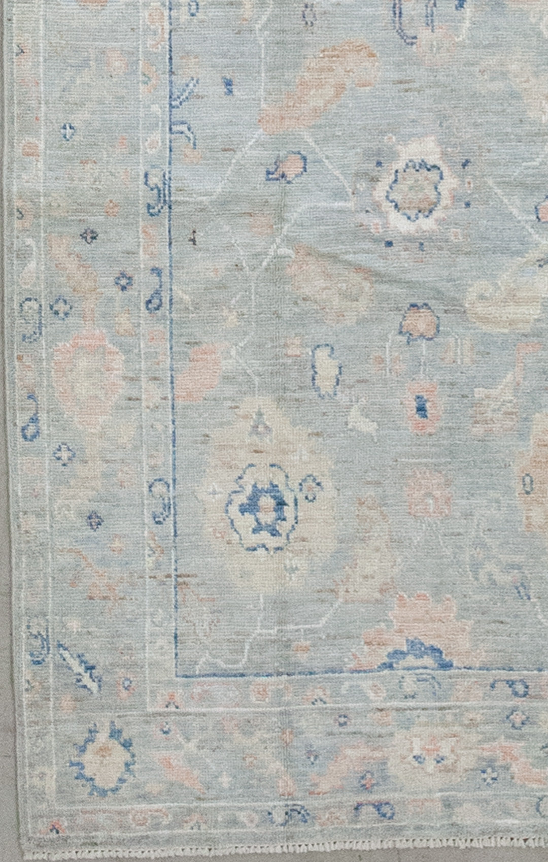 From the bottom left corner towards the perimeter, there are two thin borders containing the number 9 shape as a pattern in beige, blue, and orange.