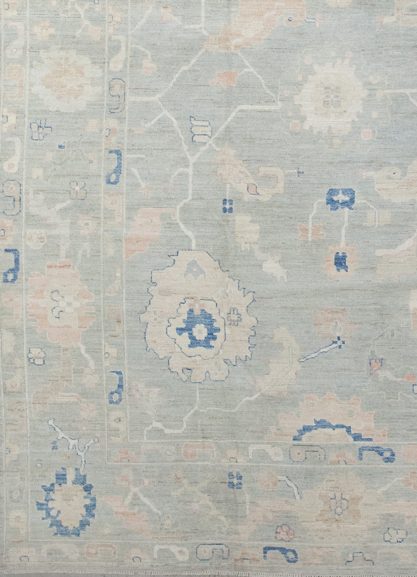 From the bottom left corner towards the perimeter, there are two thin borders containing the number 9 shapes as a pattern in beige, blue, and orange.