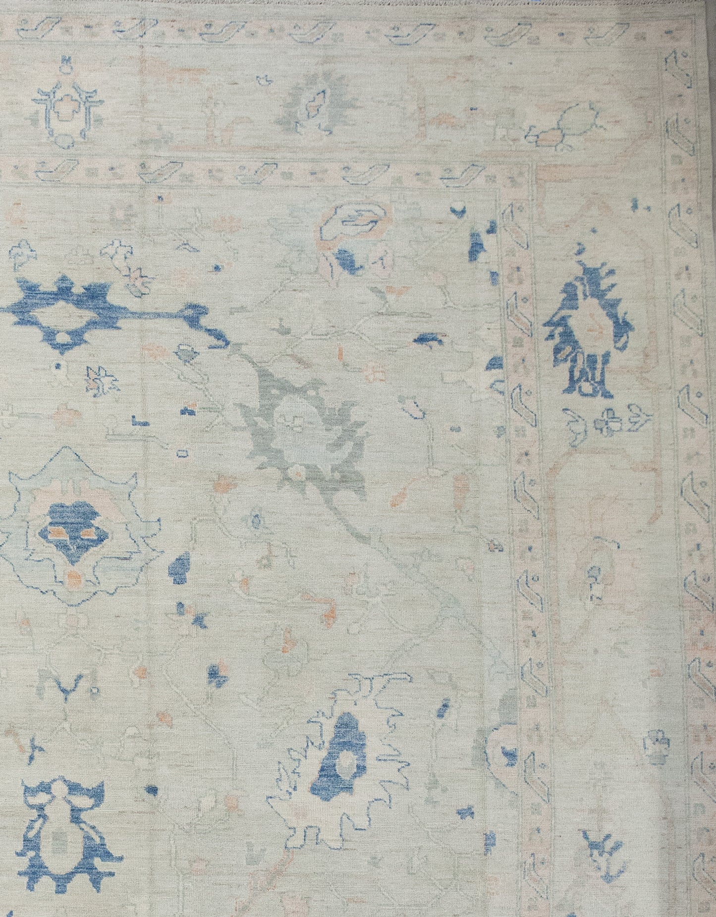 The borders have a double-line outline while the frame renders beige branches holding blue flowers.