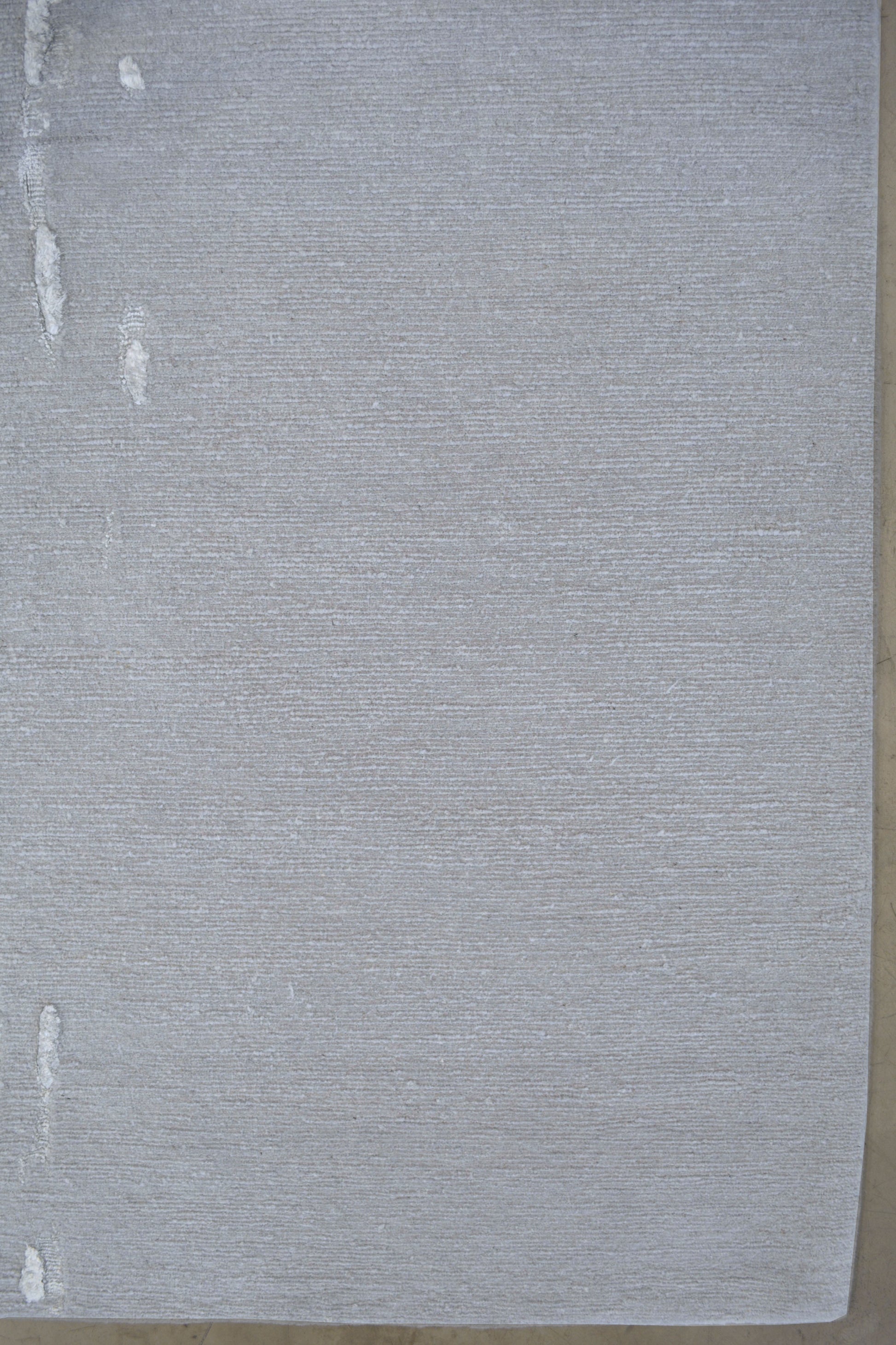 On the bottom right corner, the gray background shows more because the waterfall gets thiner when it is falling.