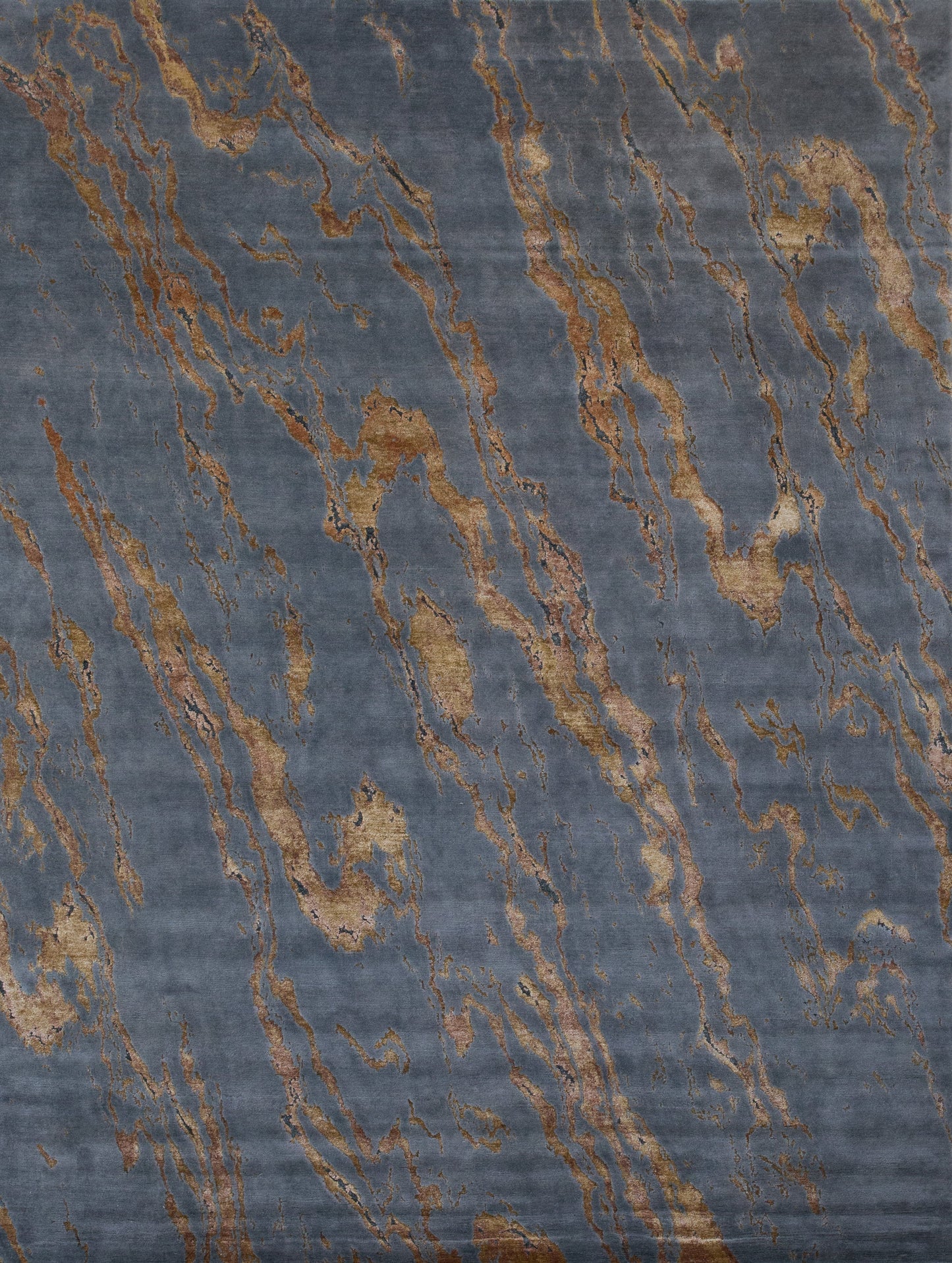 Modern rug with dark gray background and a golden marble pattern on top.
