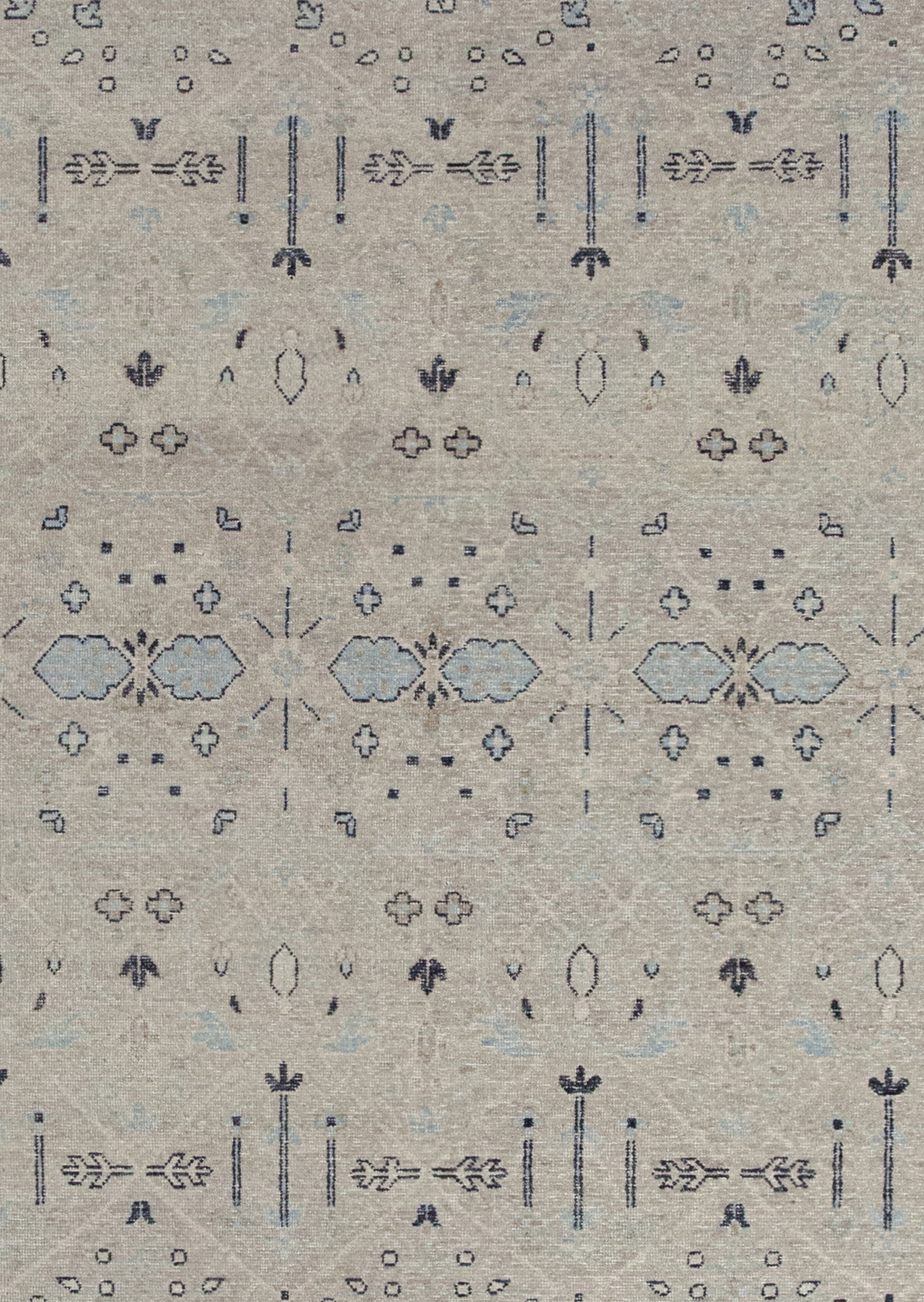 The rug's background is beige with the black outlined composition and blue details on top.