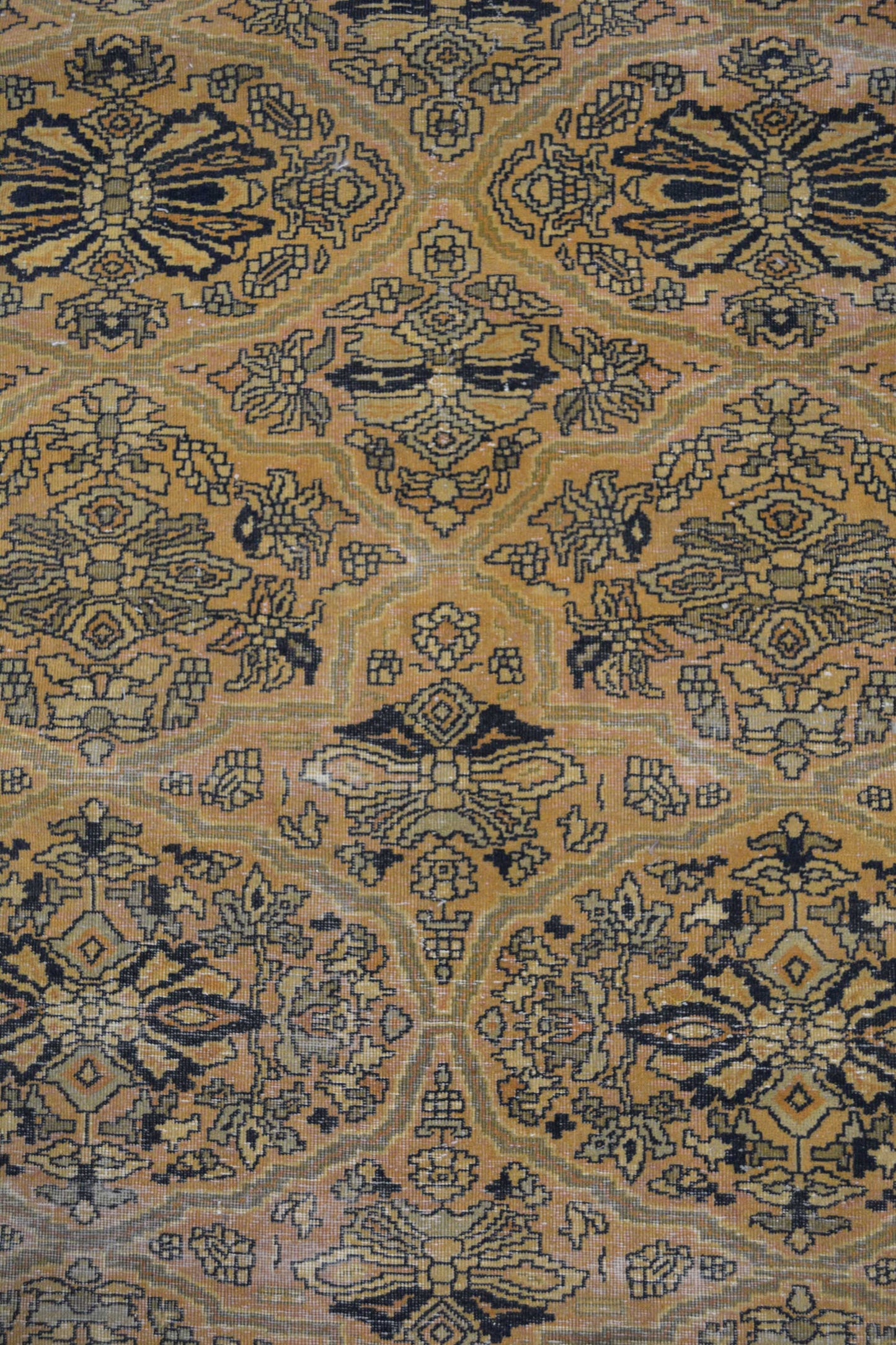 In the carpet's center, the pattern renders different abstract versions of a sunflower.