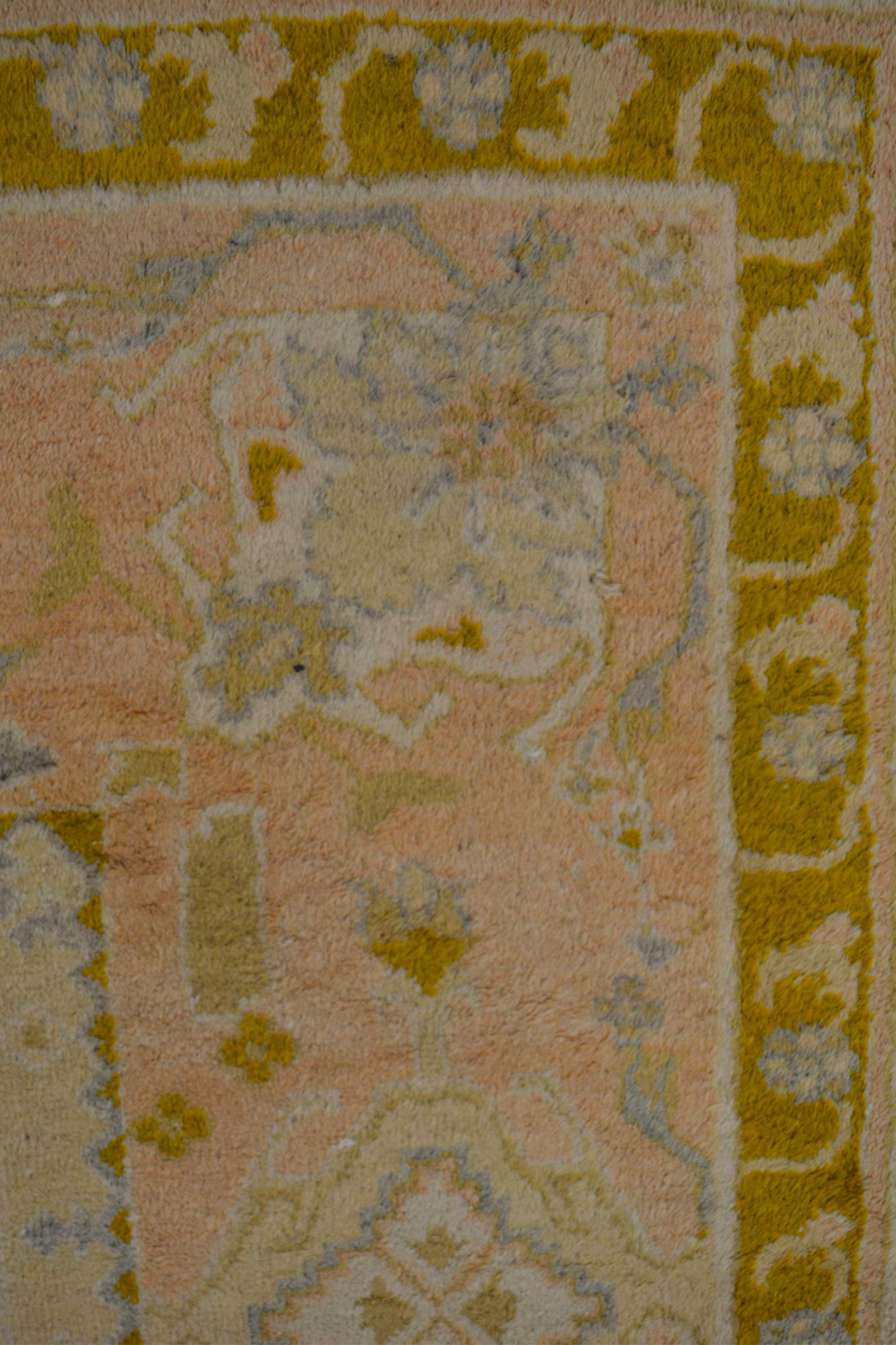 After that, this beautiful rug has a border in a copper color followed by a thicker frame that is a shade of dusty pink.