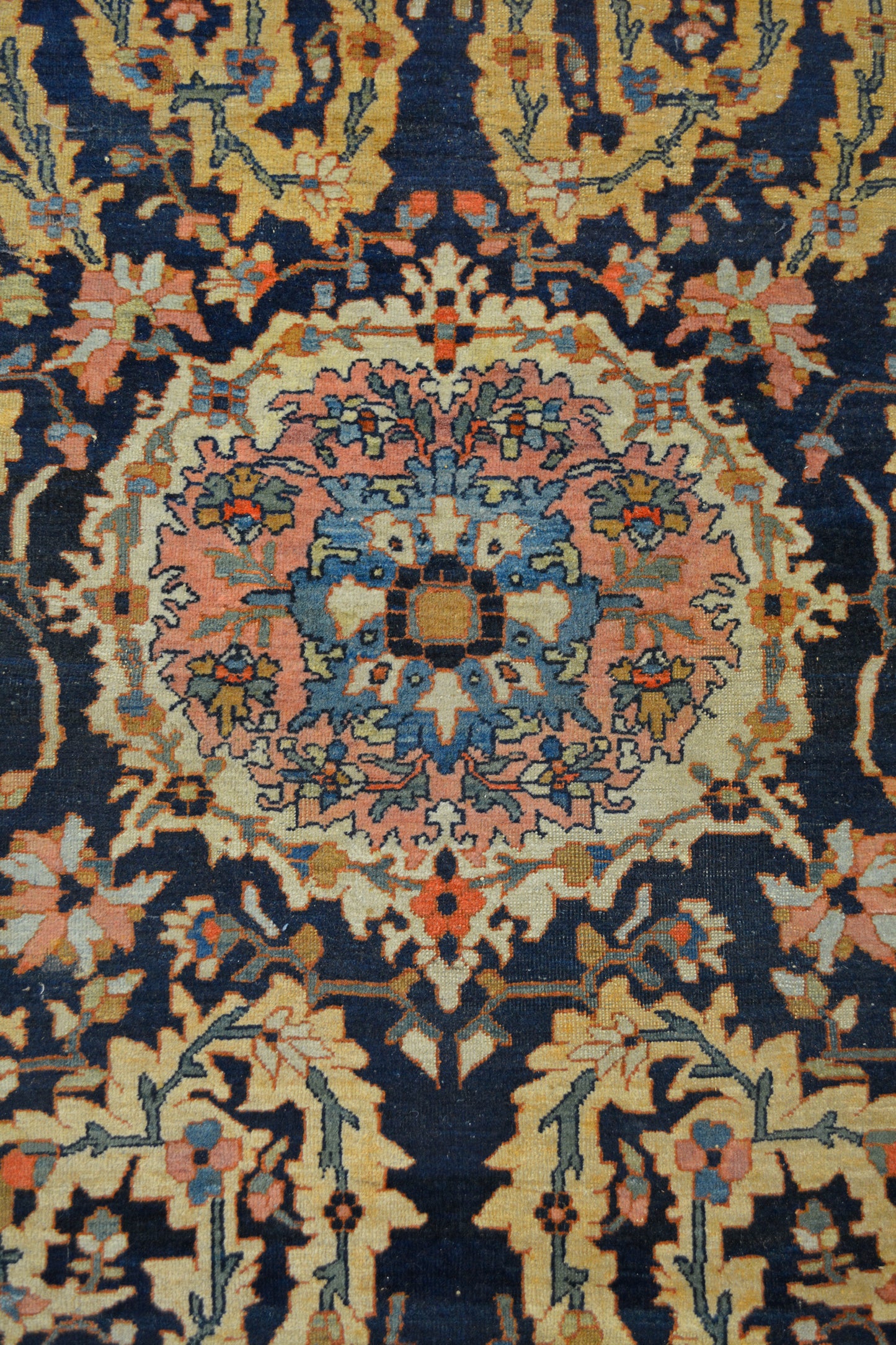 The center of the rug is a coral composition with white, salmon, blue, yellow, and green color scheme.