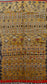 Yellow Marrakesh rug with fringes on the bottom and a tribal pattern.