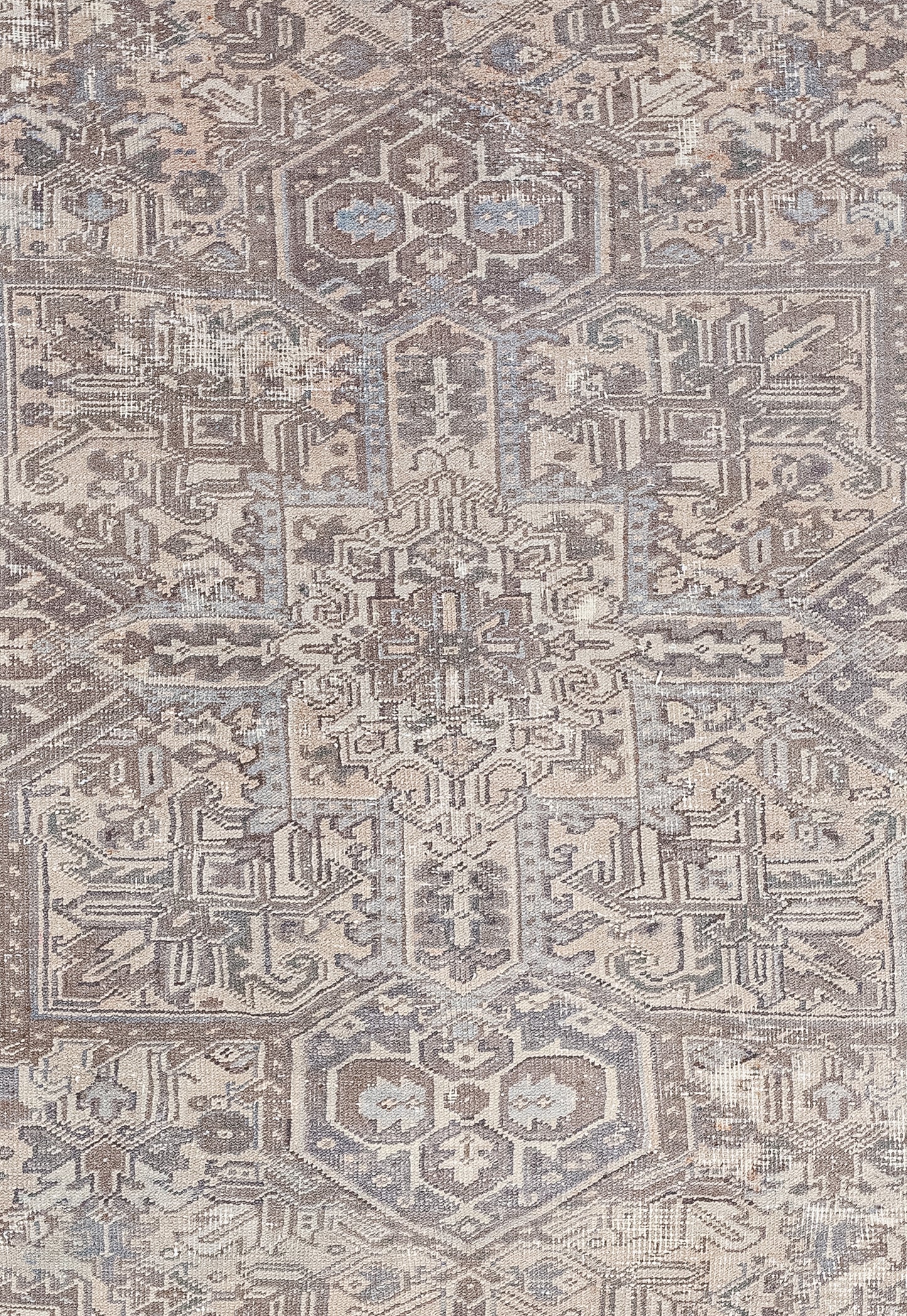 The center of the rug features a square cross that is made up of many tribal symbols that are also found throughout the rug.