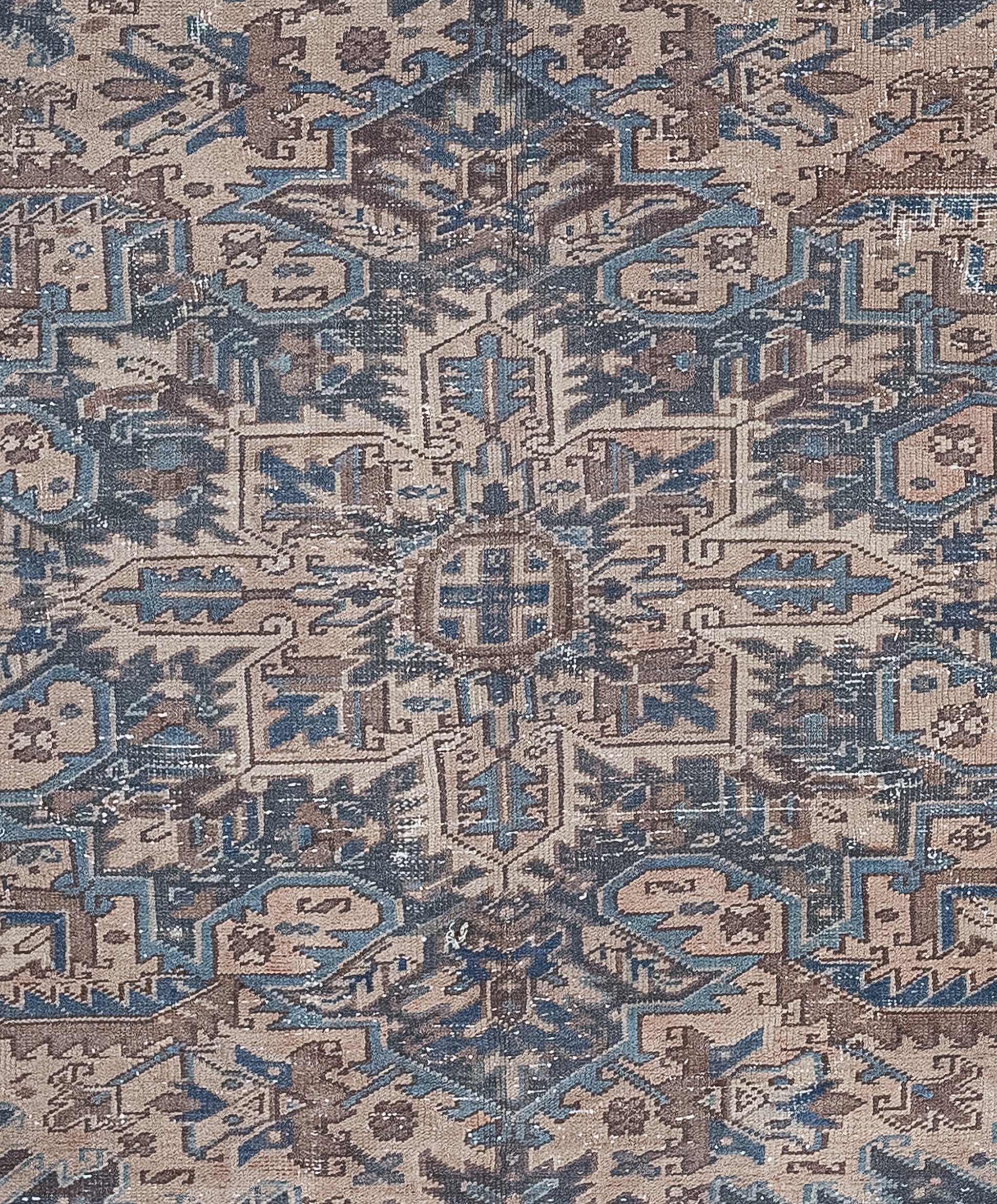 The close-up features many symbols arranged into rhombus' shapes that have pointed vertices all over the rug.