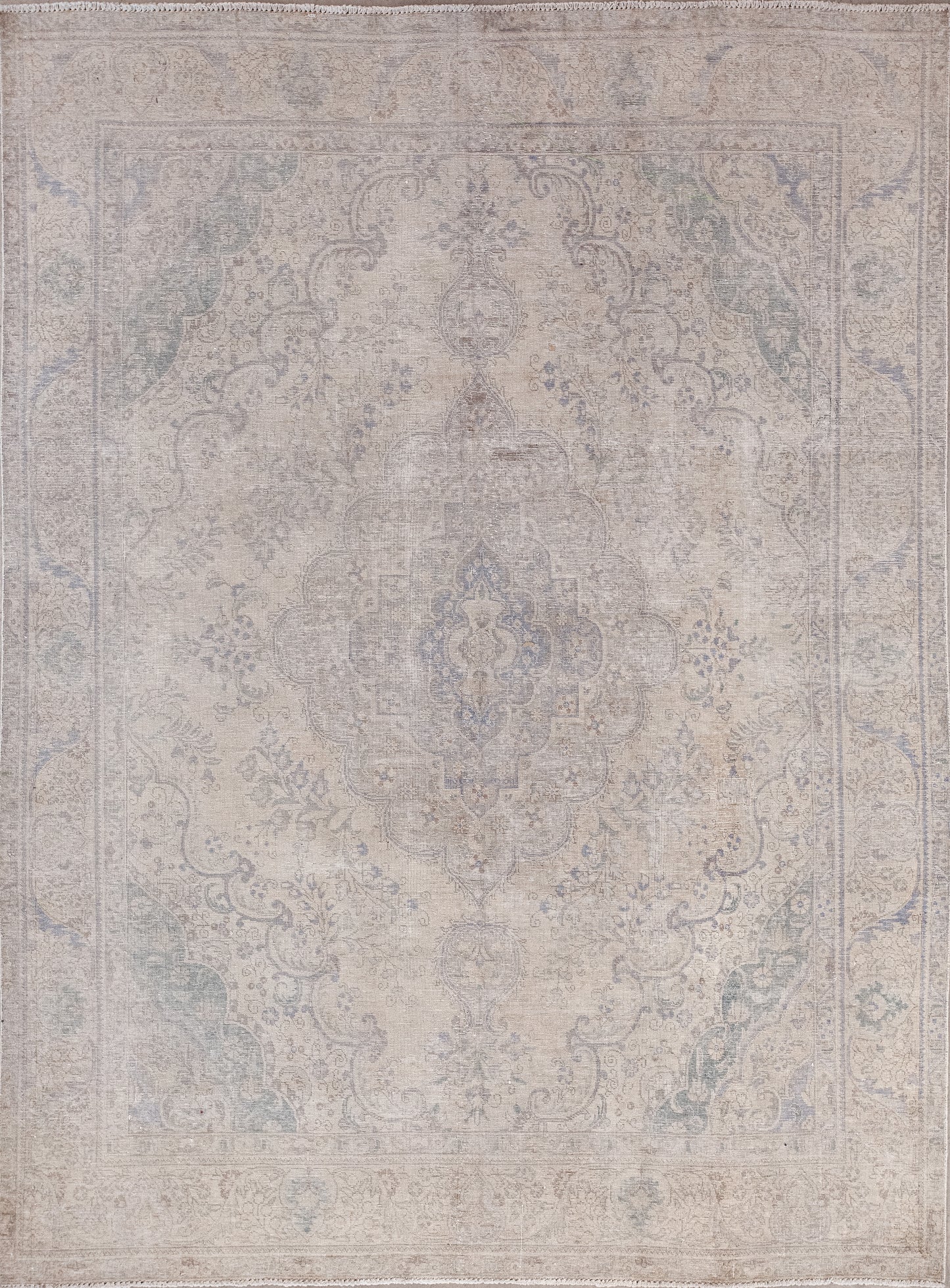 This traditional rug was woven in hues of royalty. The aged natural color scheme has beige for the background, gray for the pattern. The combination of both restrains the contrast. 