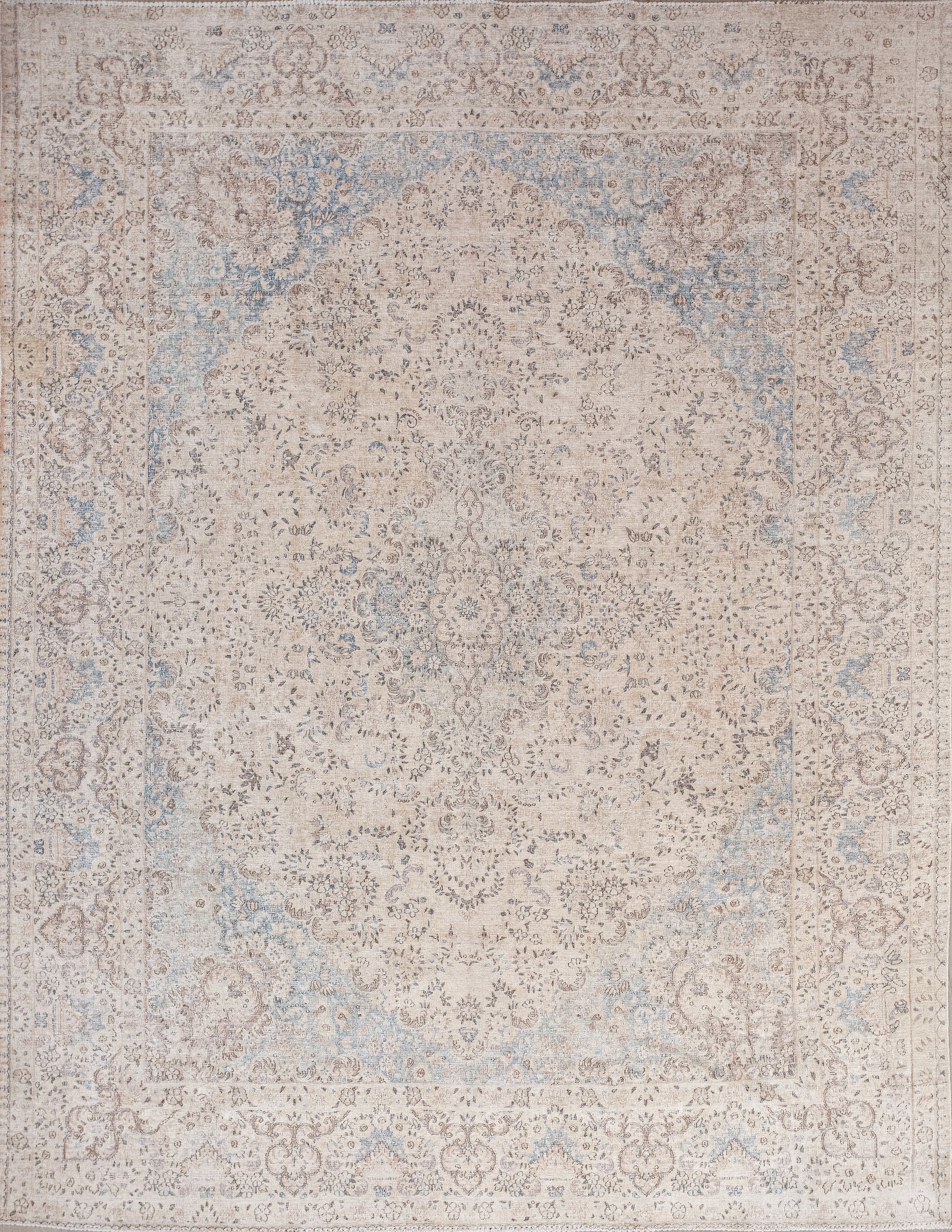 This old-fashioned rug was woven with an air of distinction. The color palette has browns and blues ranging from light to dark tones.