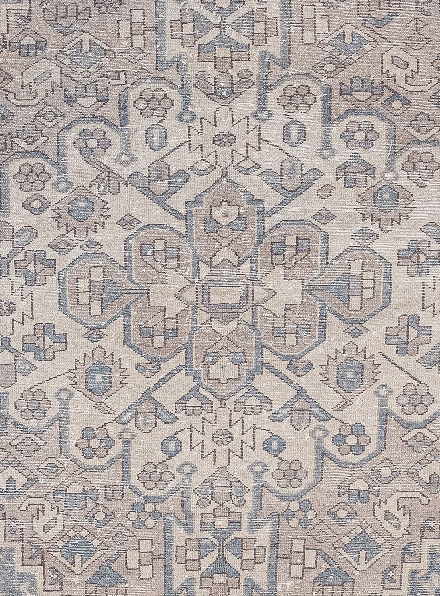 The close-up of the carpet  features an organized design made up of many small abstract squares, hexagons, triangles, and polygons, all arranged symmetrically.