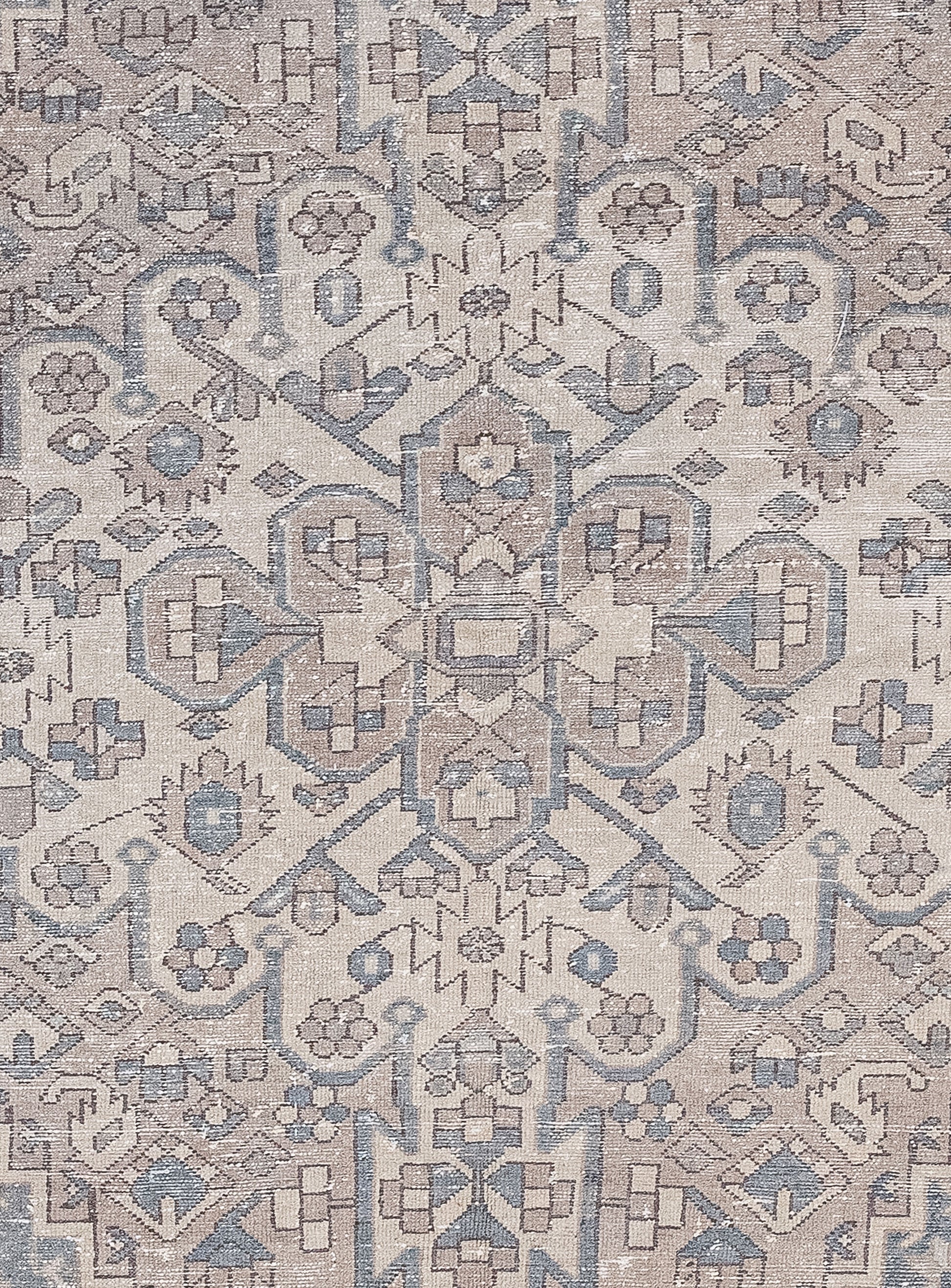 The close-up of the carpet  features an organized design made up of many small abstract squares, hexagons, triangles, and polygons, all arranged symmetrically.