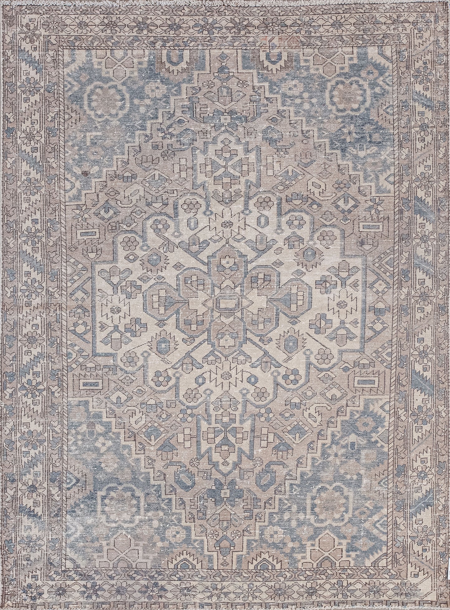 This pyramidal rug was woven with ancient symbols and tribal energy. The old-fashioned color scheme has beige, brown, and blue-gray. 