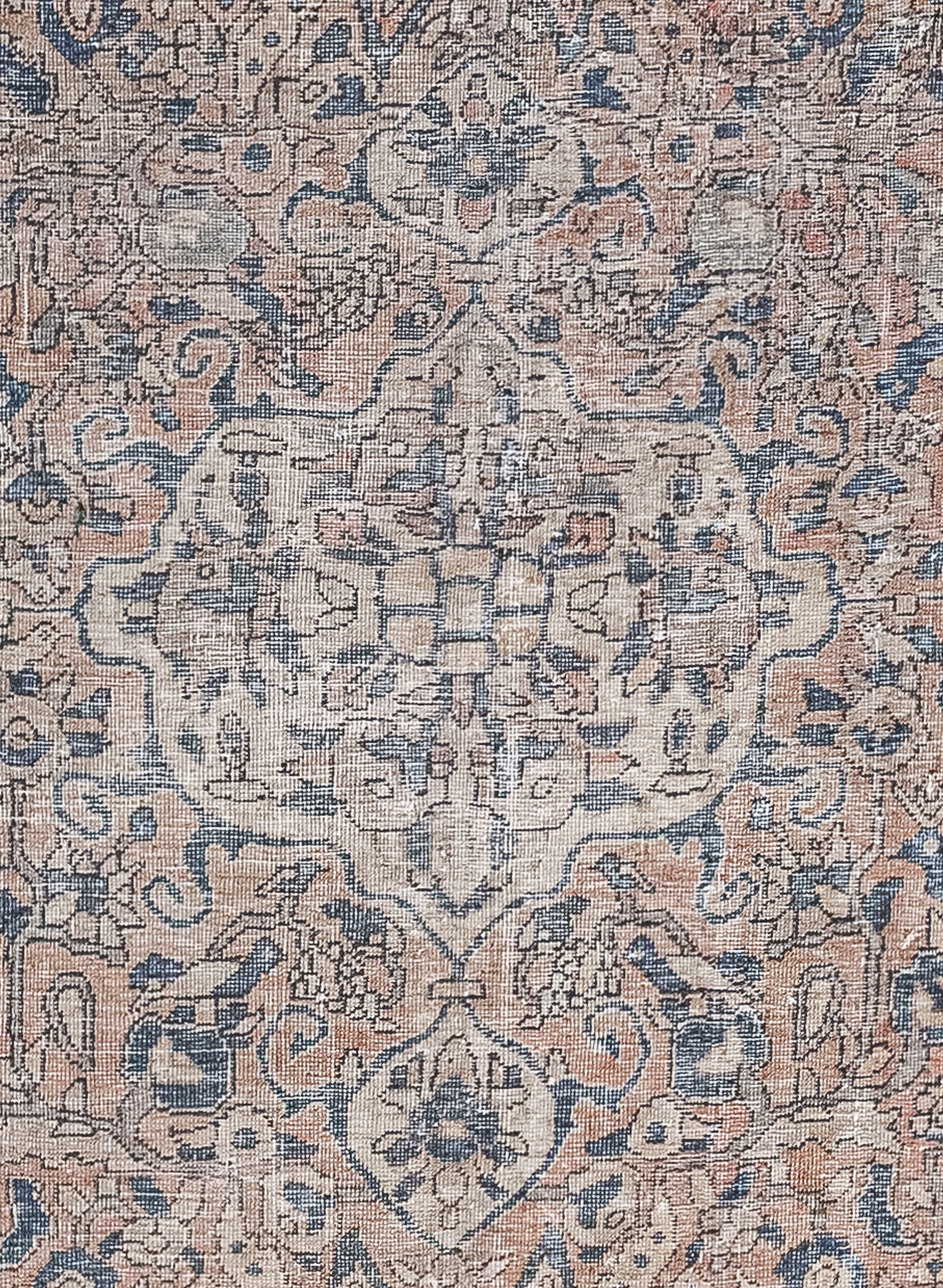 The rug's close-up displays an embellishment fused with two smaller ones at the top and bottom. This ornament is filled with geometric flowers, leaves, and abstract polygons.