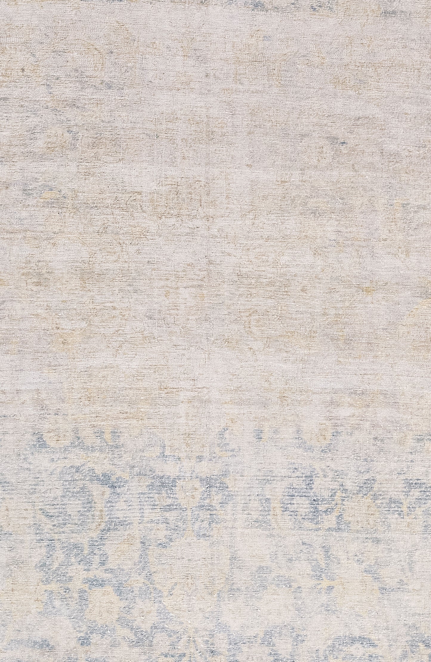 The center of the rug features a distressed beige over a slightly exposed paisley floral print that is on a blue background.