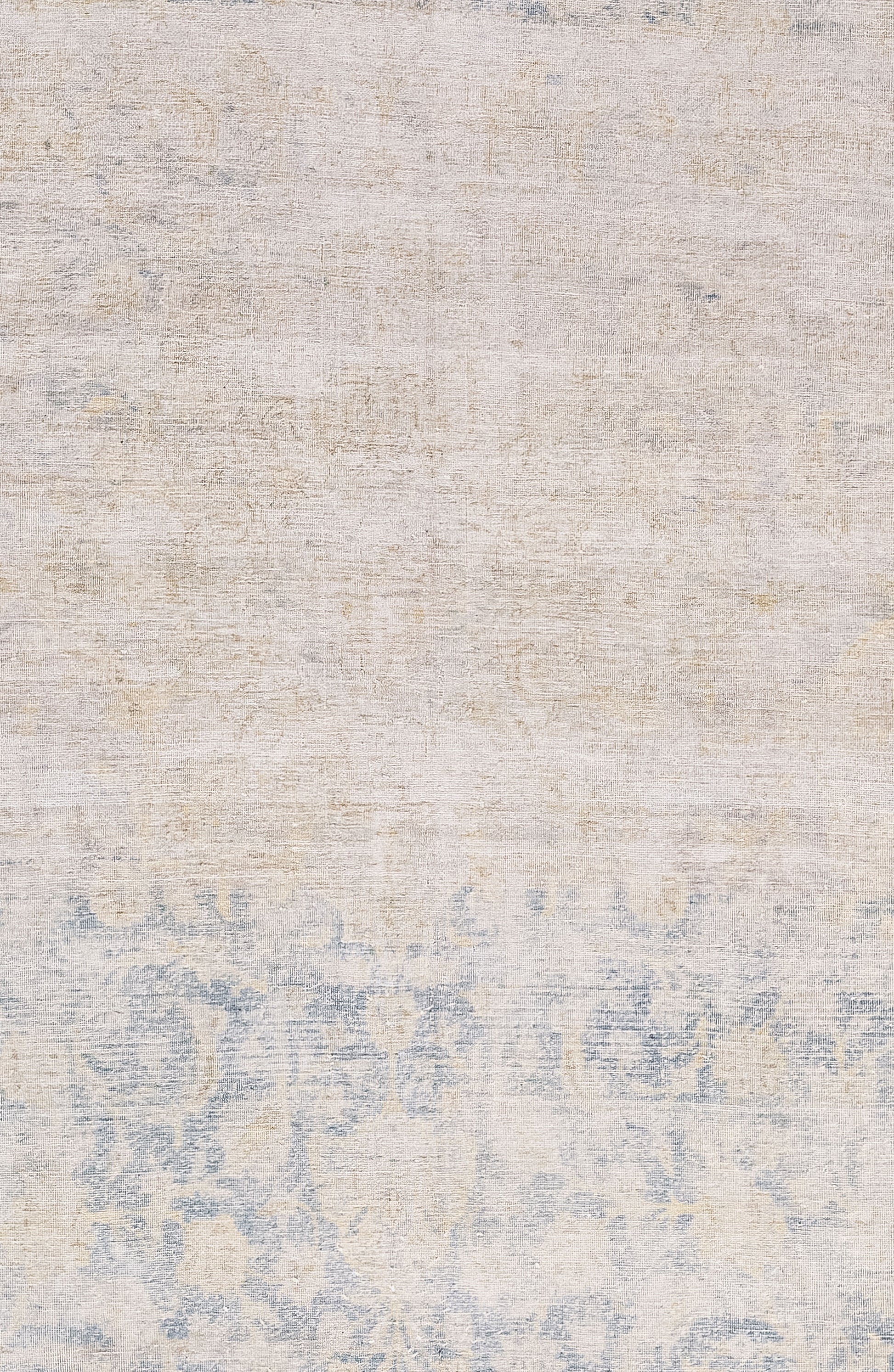 The center of the rug features a distressed beige over a slightly exposed paisley floral print that is on a blue background.