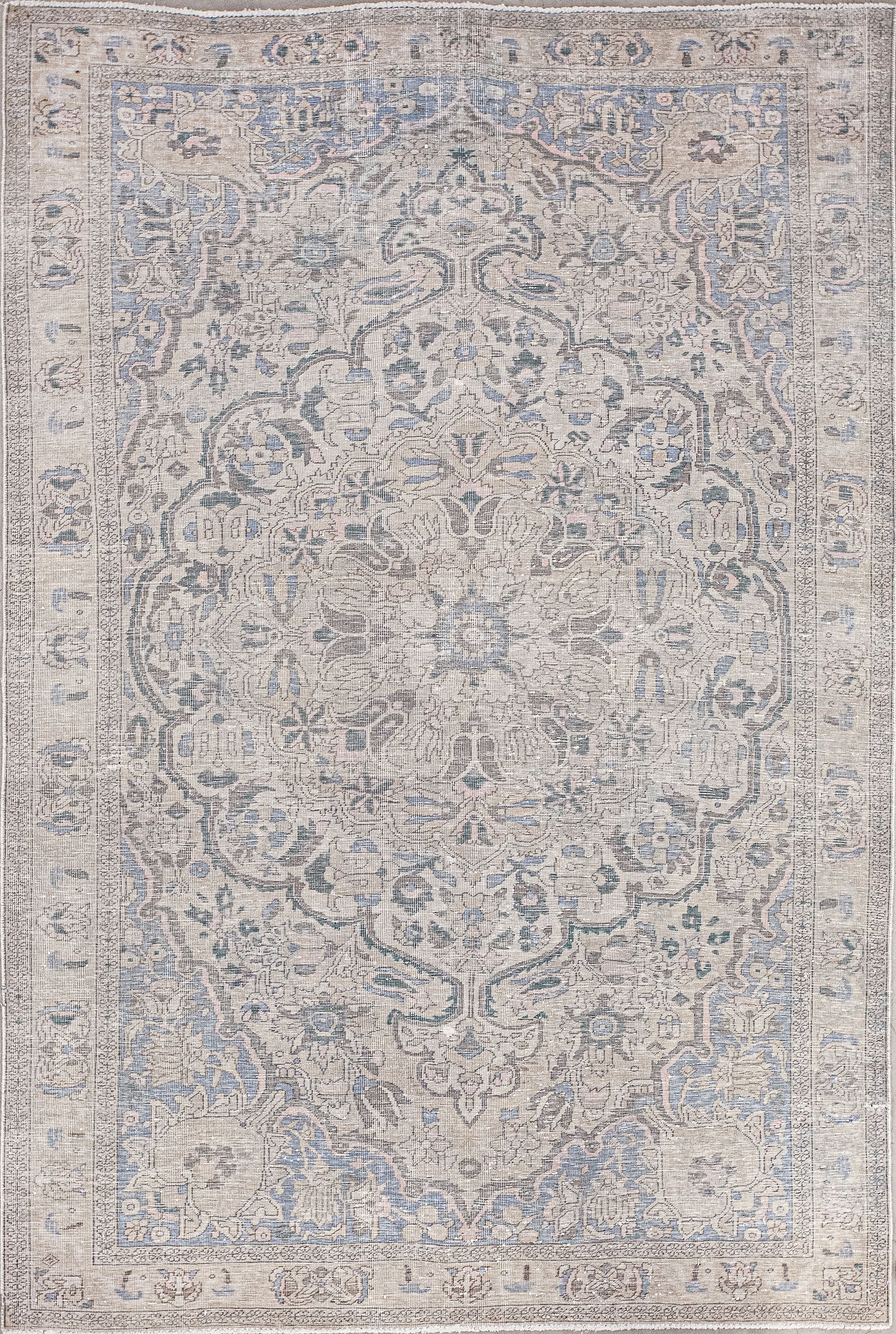 The heavily embellished rug comes with many perfectly designed details. In order to avoid an overwhelming sensation, the artisan used a simple color palette that has beige for the background, light royal blue and dark gray for accents over the pattern.