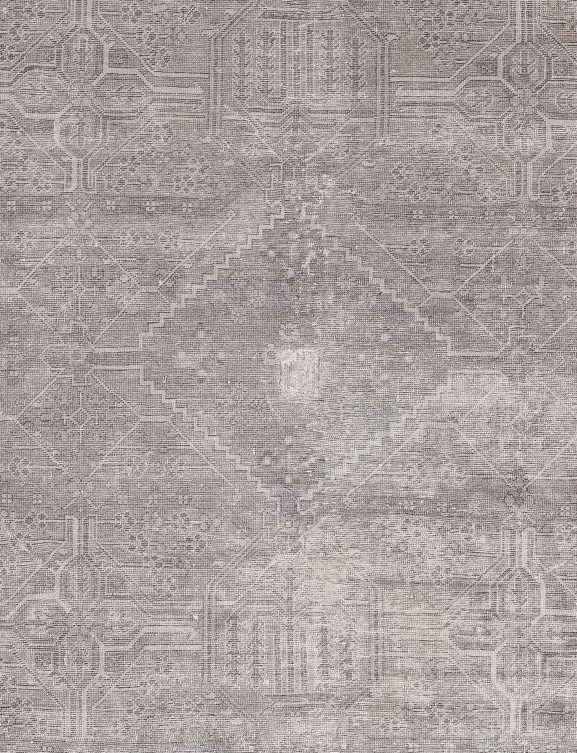 The center of the rug features two fused pyramids creating a diamond shape with abstract polygons merged on each edge. 
