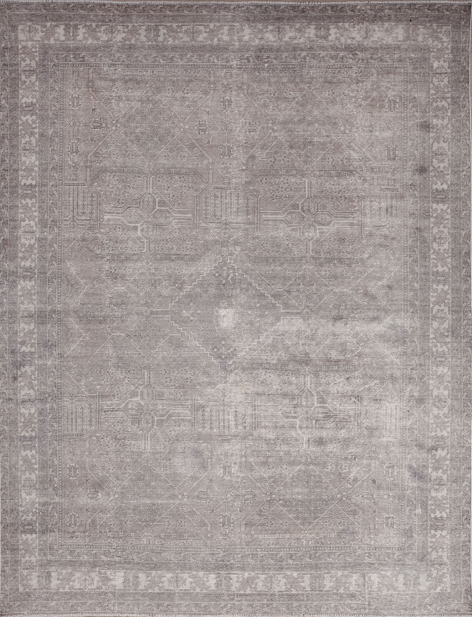 This mesmerizing rug was woven to capture your attention and make you look at it a little deeper. The balanced color palette has various shades of gray and brown accents.