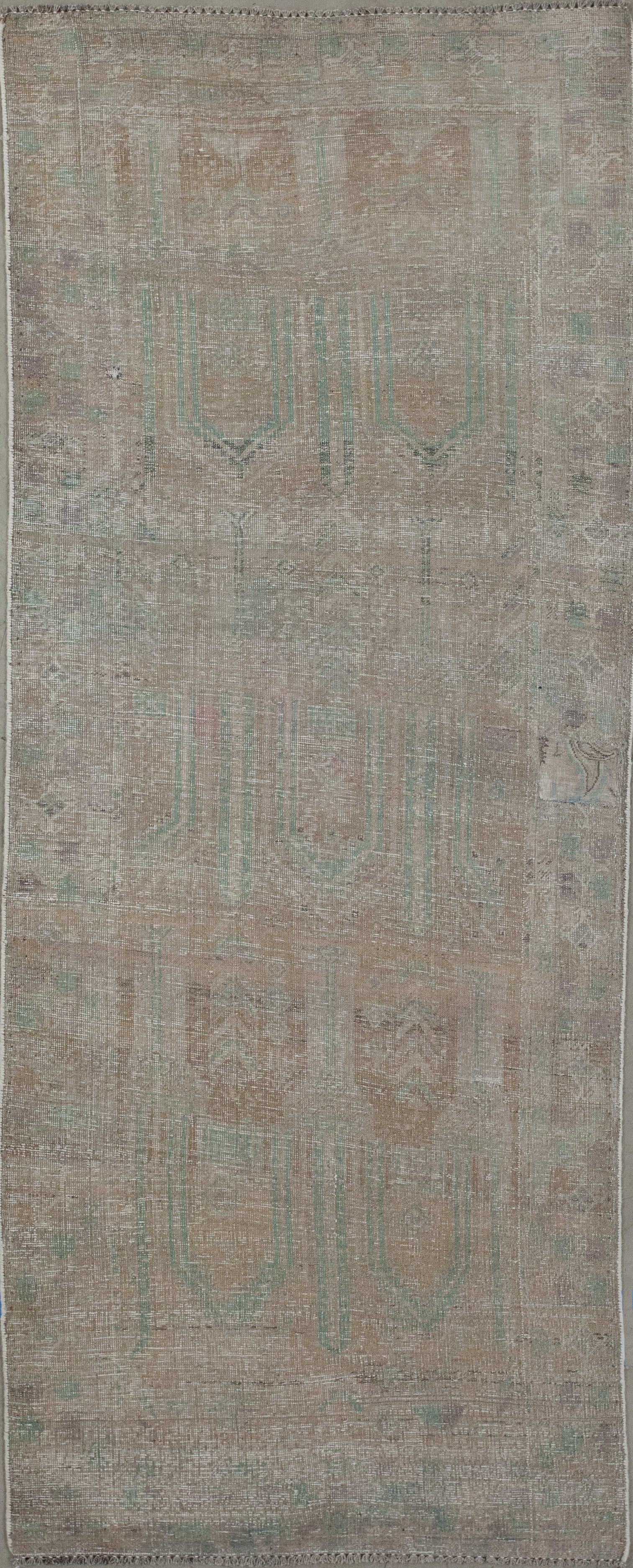 runner rug with a tenuous turquoise pattern.