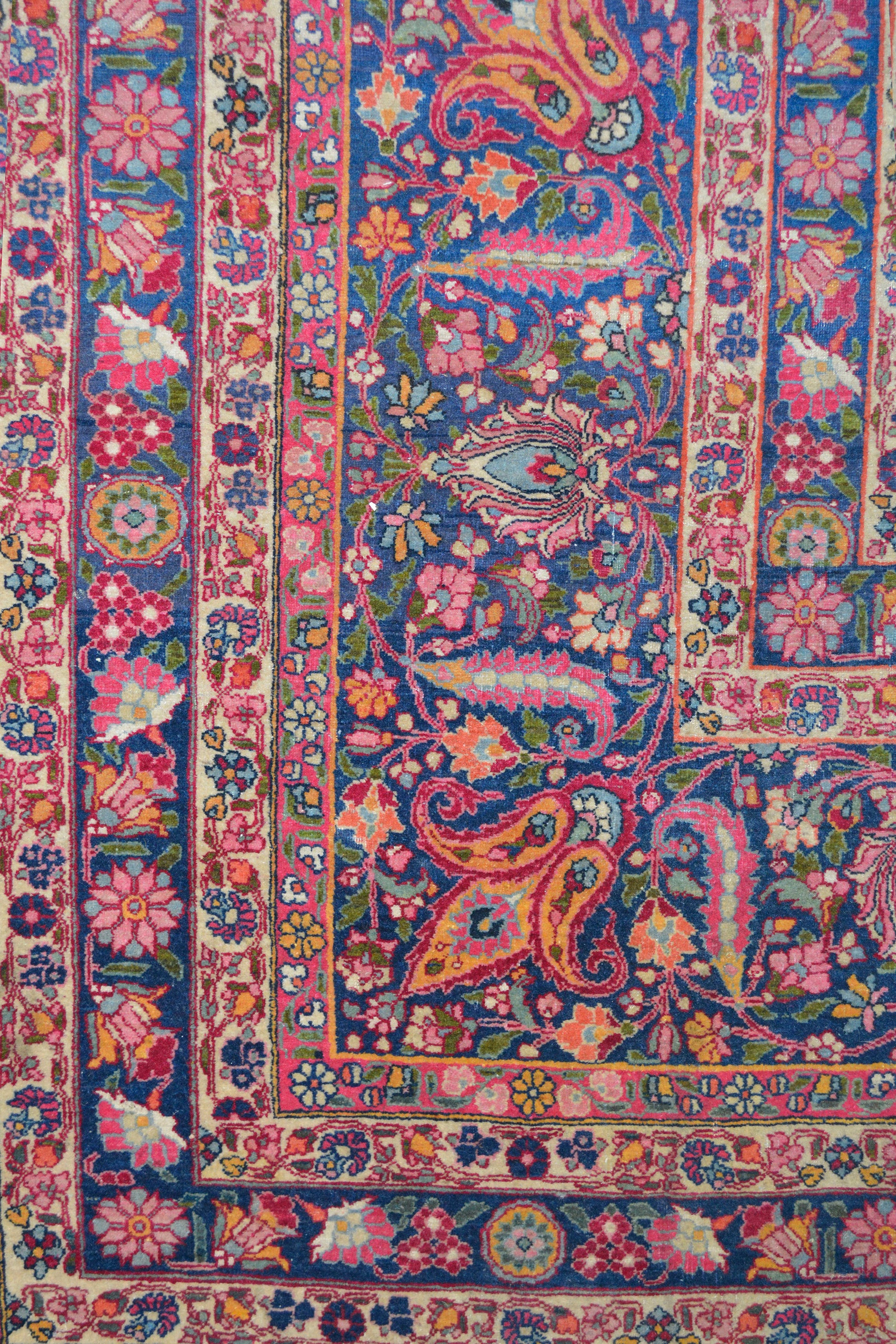 Also, this carpet has ten frames around it. The left bottom corner shows frames with a flowers pattern inside. The color scheme is royal blue, pink, fuchsia, white, yellow, and cyan. 