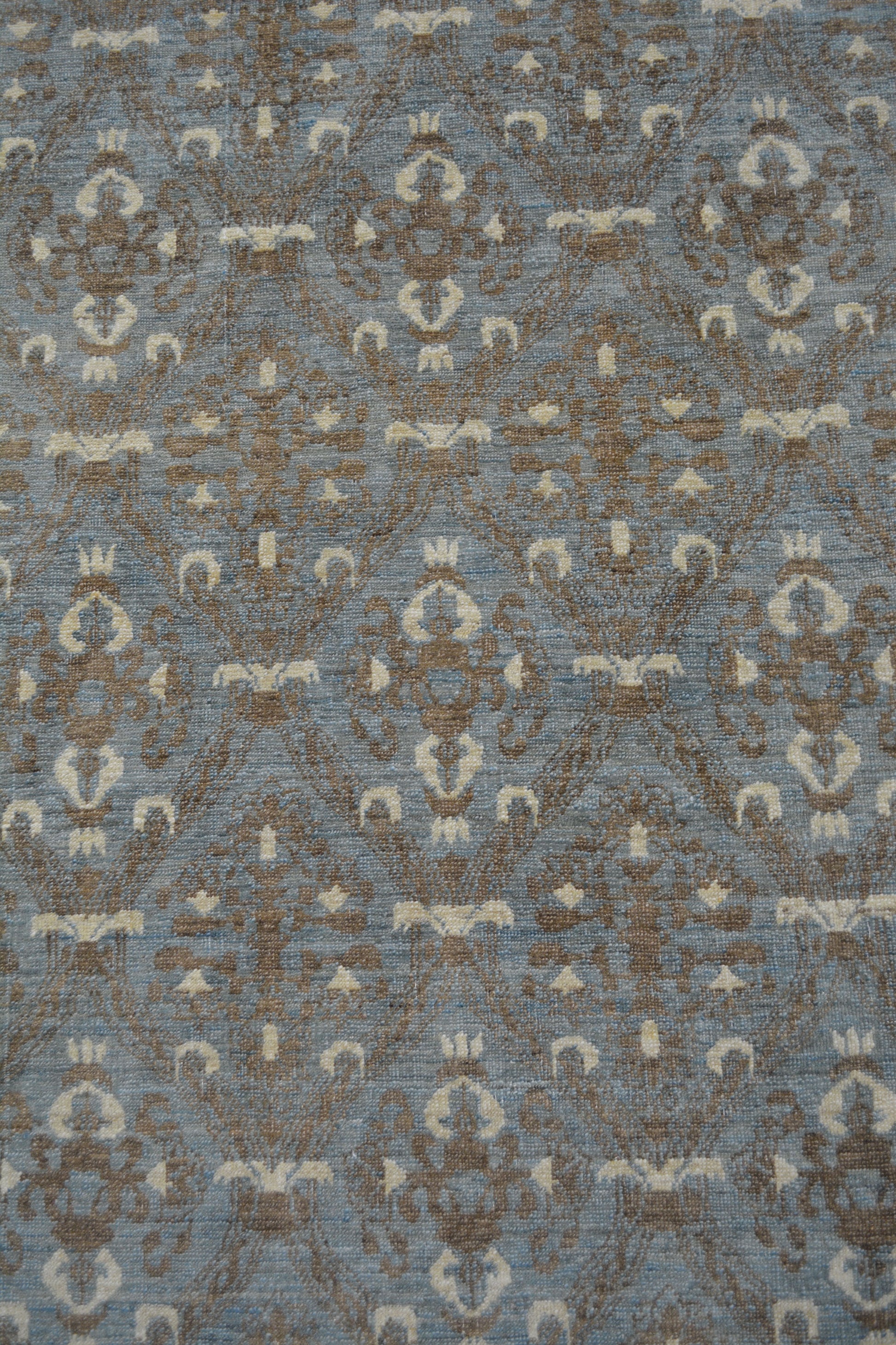 The center of the rug features the candelabrums, and ornaments organized symmetrically. 