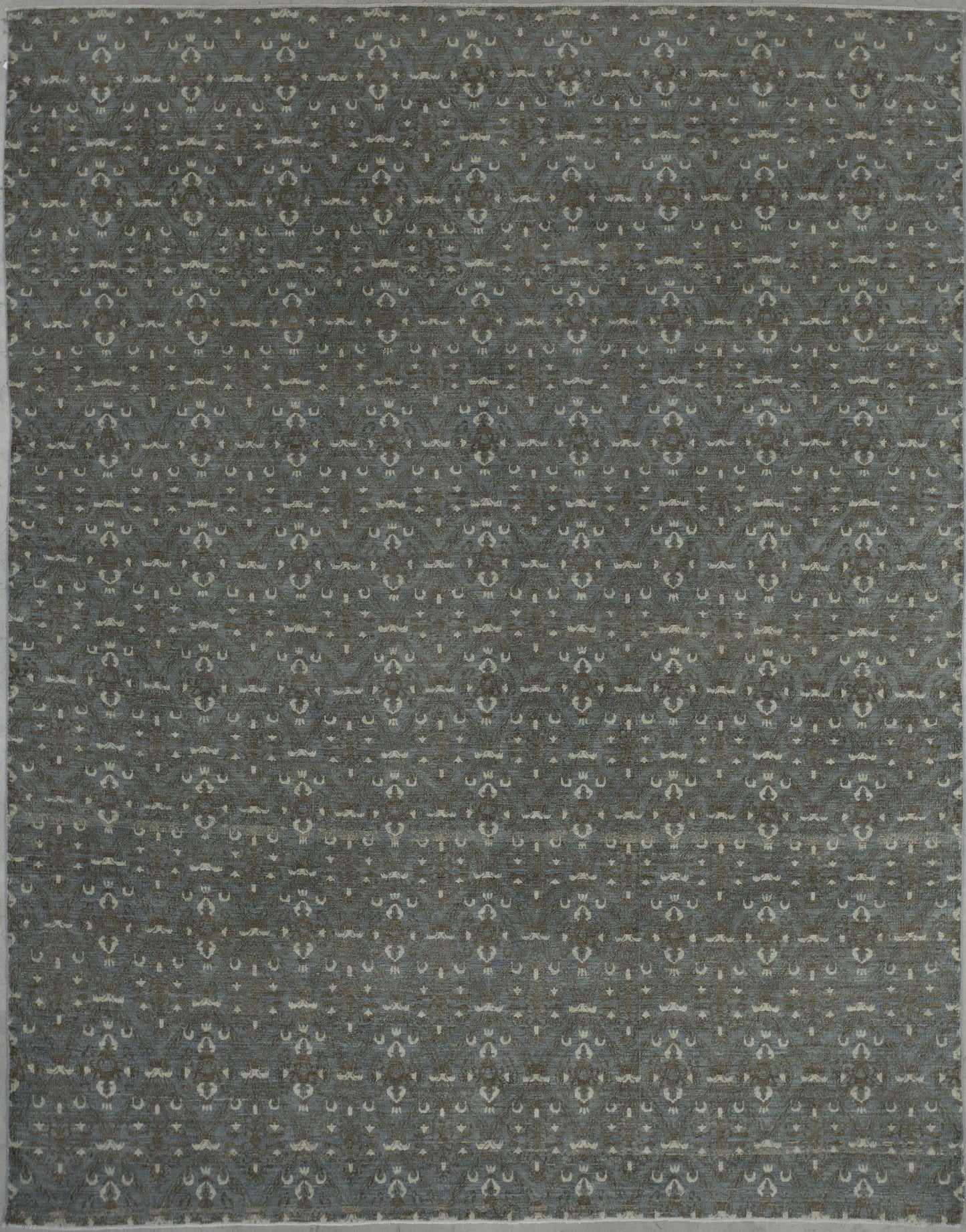 This posh carpet belongs to the bamyan collection. The color scheme has beige to represent candles in the pattern, copper for the candelabra lamp abstraction, and gray for the background.