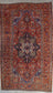 Treasured rug knitted with a geometrical pattern.