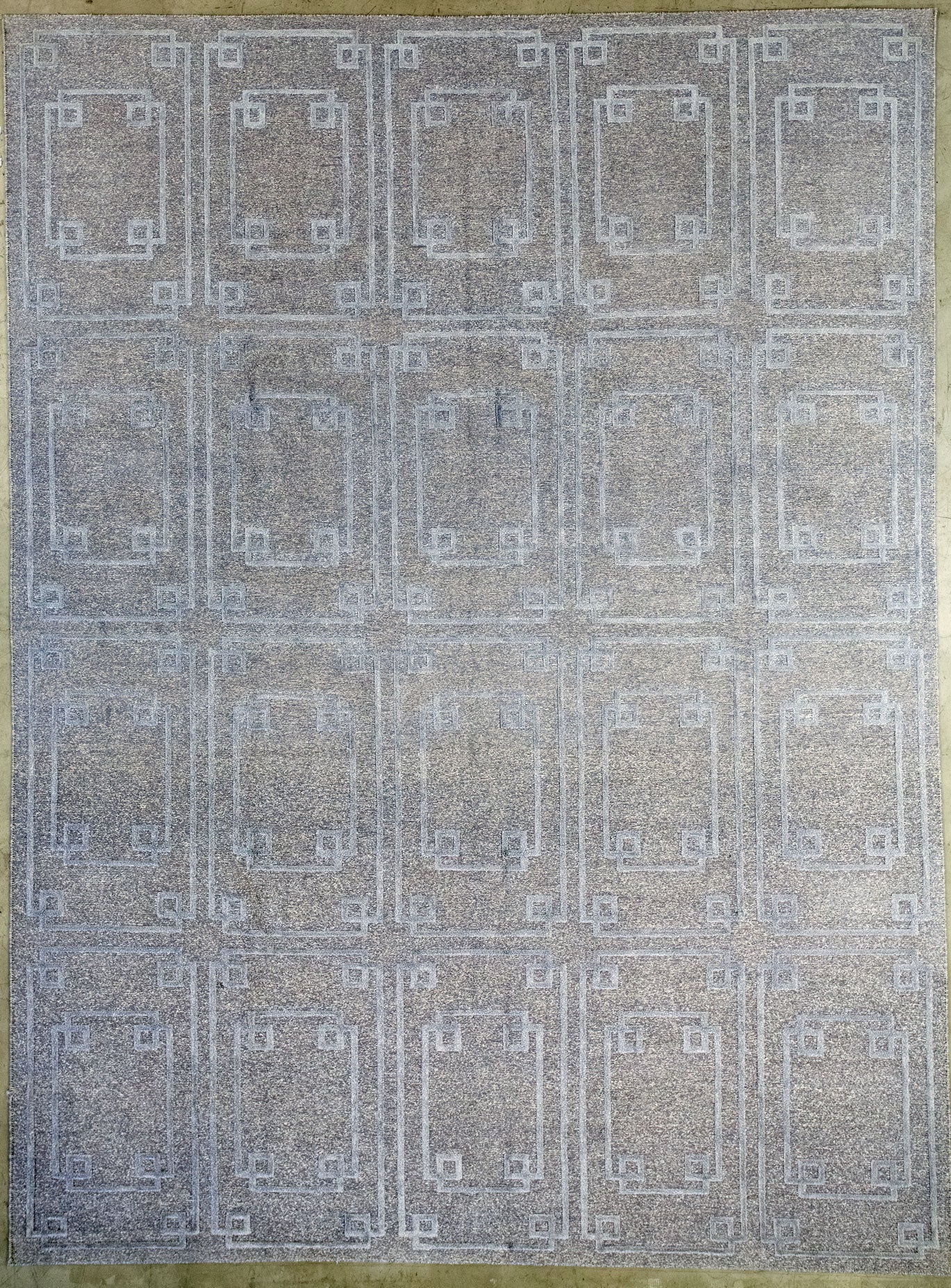 Minimalistic carpet has gray background, and its pattern in light gray for contrasting purposes. This monochromatic rug has a rectangle pattern, which is composed by five columns of vertical ones and fours rows total.